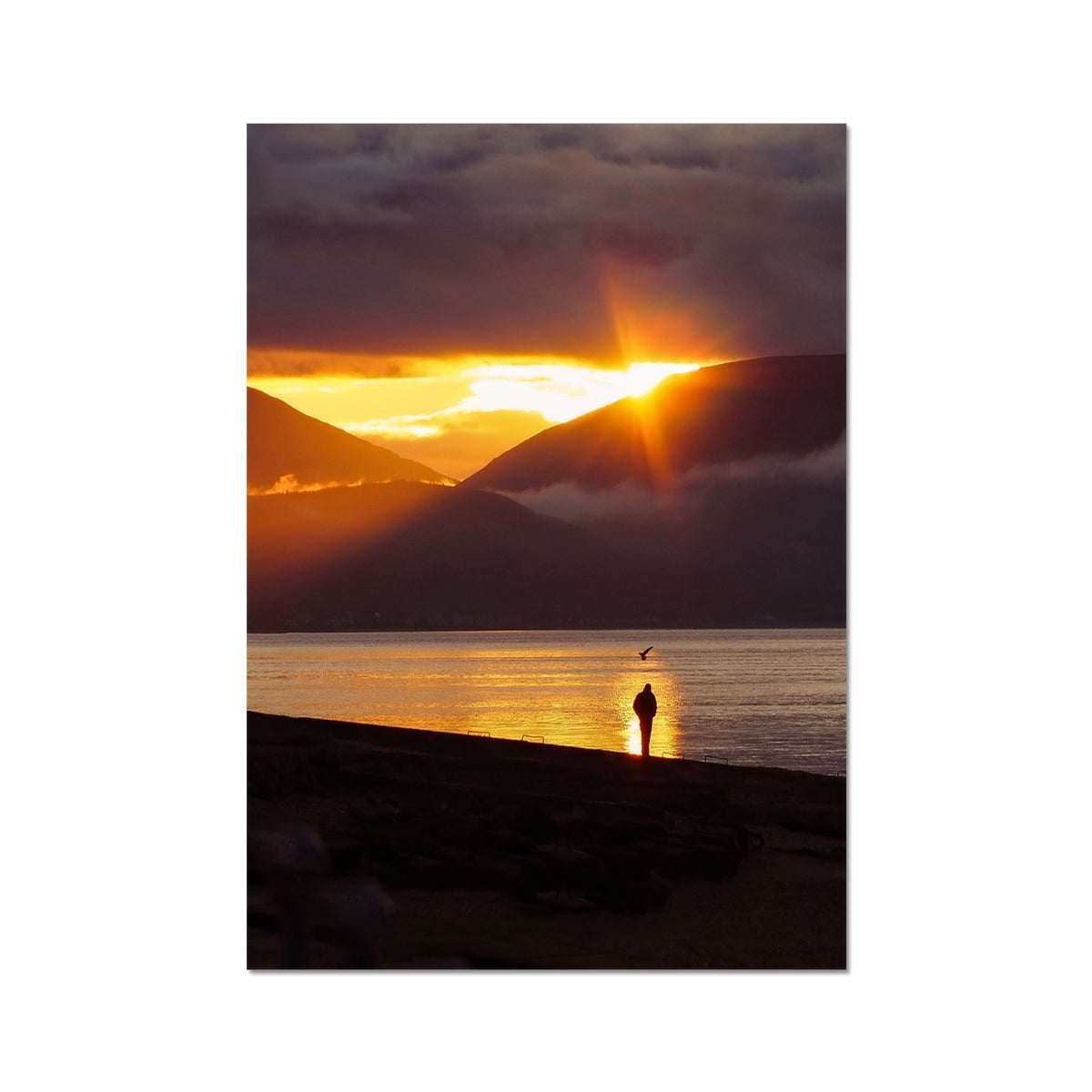 Silhouetted figure on dark shoreline at sunset, Reflecting at Sunset print