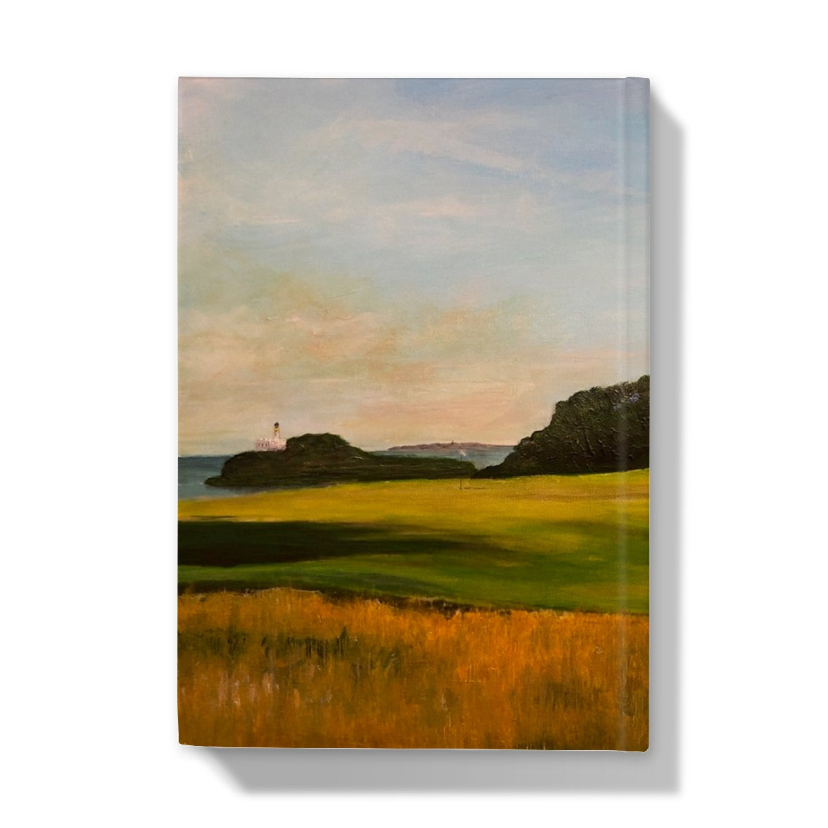 Renaissance Golf Club journal with golden fields, hills, and lighthouse