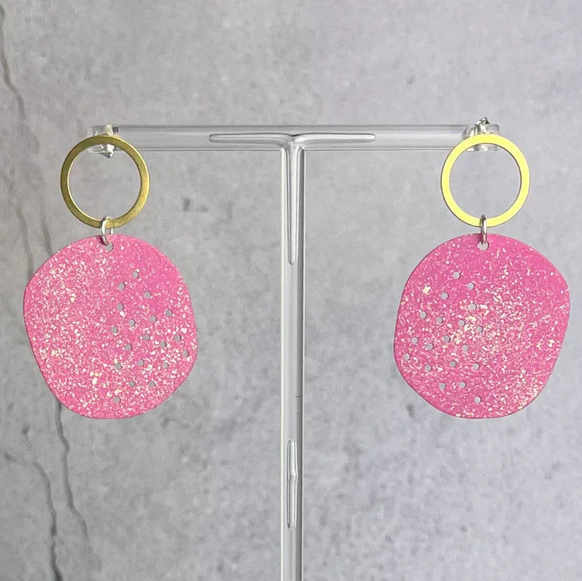 Vibrant pink glittery perforated circular earrings with gold hoops, Santa Cruz Cesar by Lindsay Mcdowall Jewellery