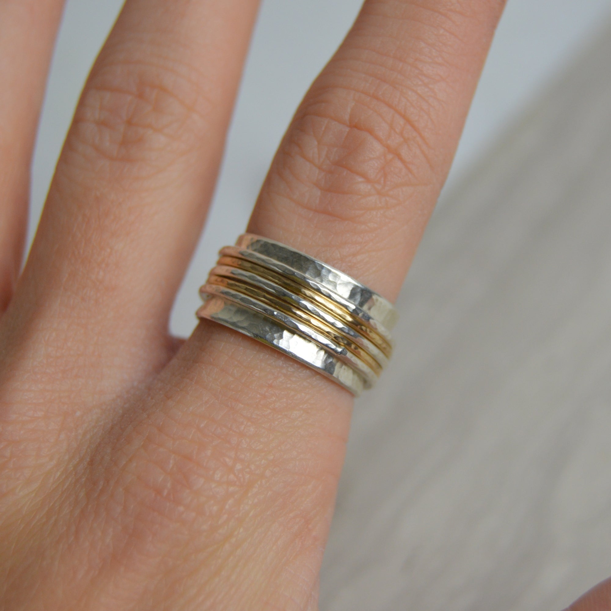 Hammered silver spinning ring with gold bands by Lindsay Mcdowall Jewellery