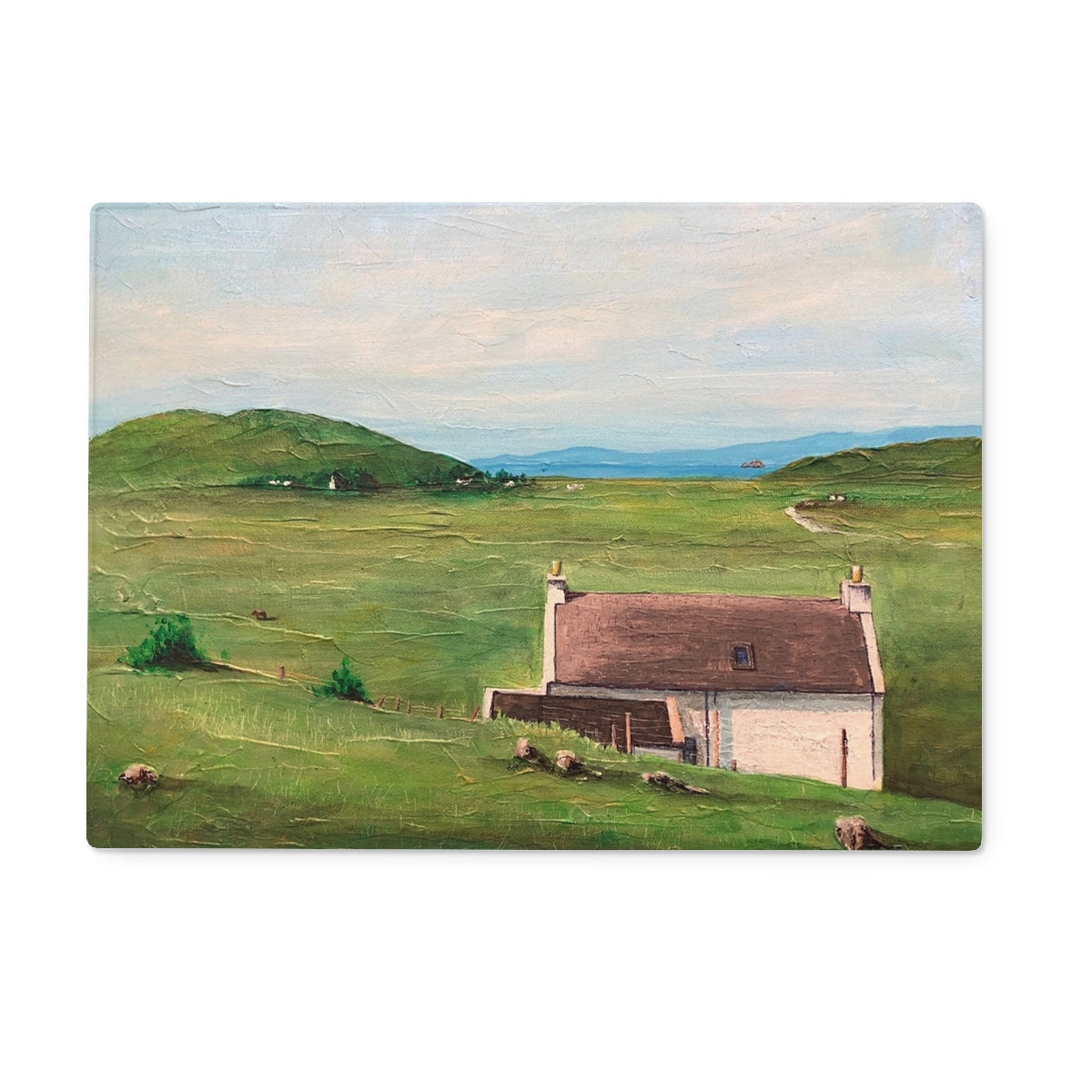 Painting of a white house with a brown roof in a green landscape on A Skye Cottage Glass Chopping Board