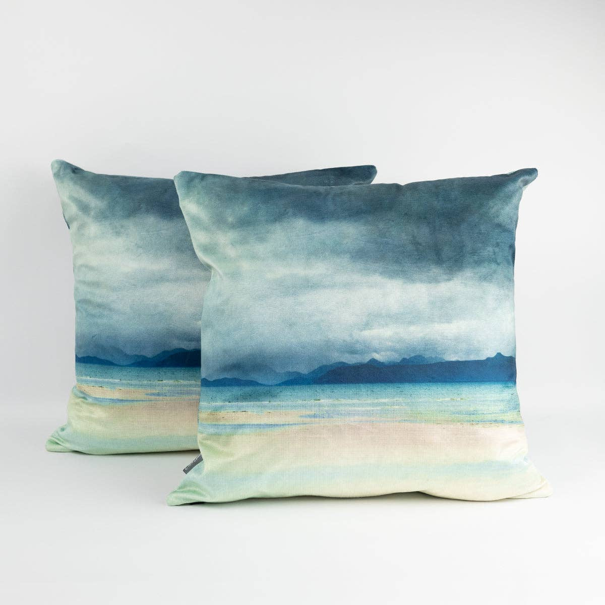 Skye and Raasay velvet cushions with watercolor seascape design
