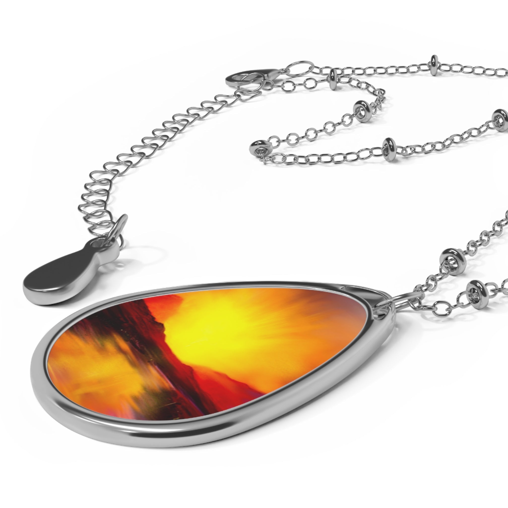 Silver-toned teardrop necklace with abstract orange and yellow Skye Sunset design
