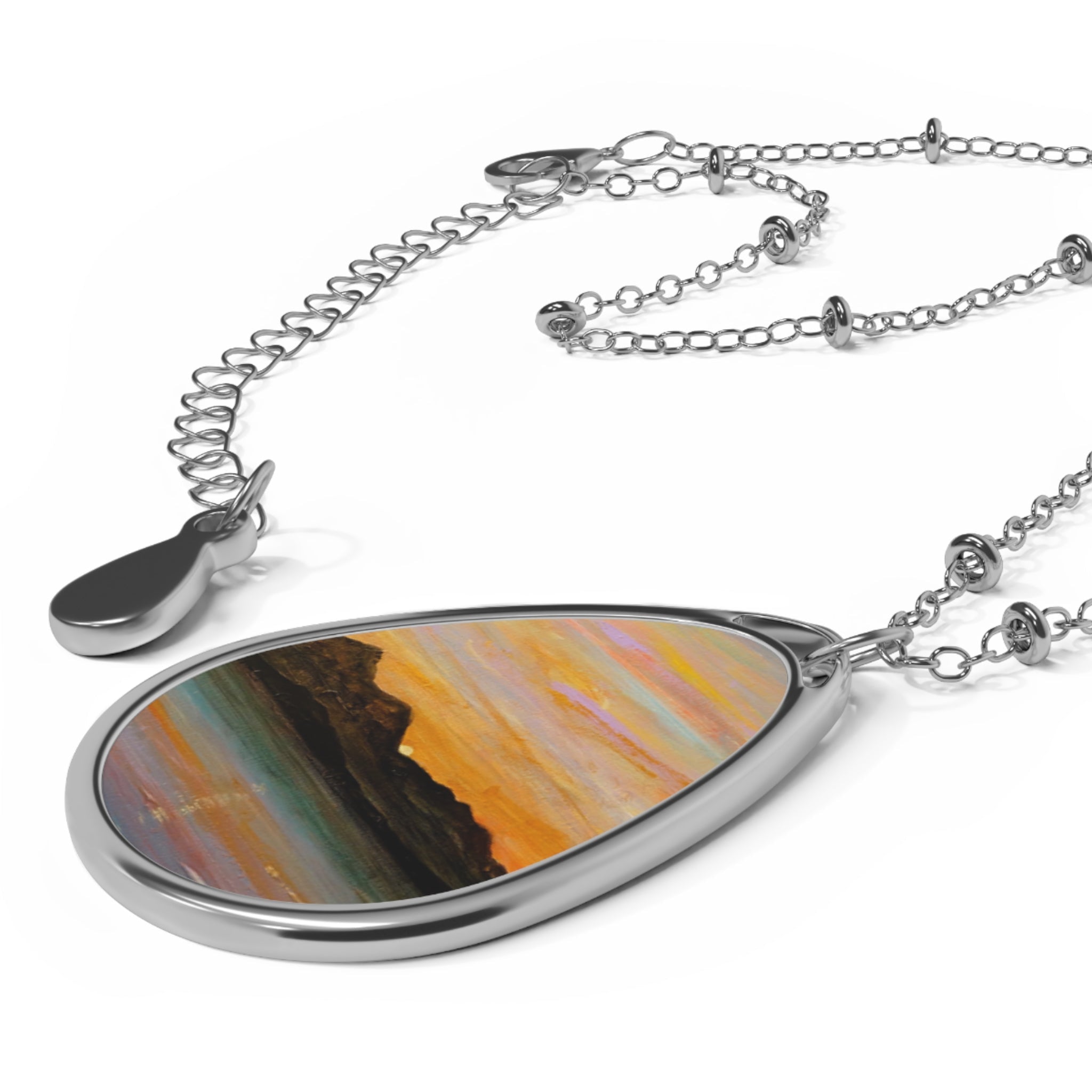 Silver teardrop pendant necklace with iridescent orange-green Sleeping Warrior Arran art