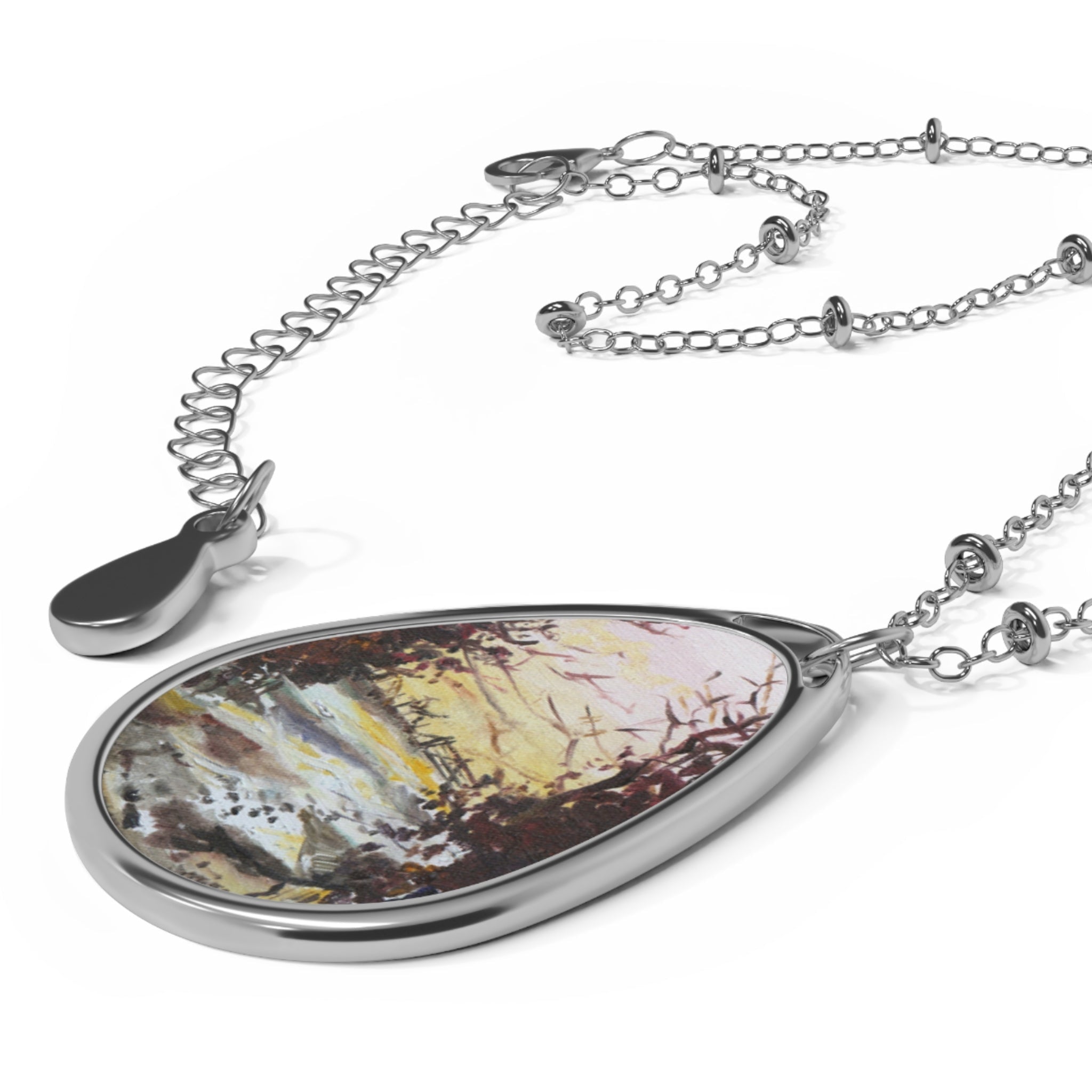 Silver necklace with teardrop-shaped pendant featuring multicolored abstract Scottish art design