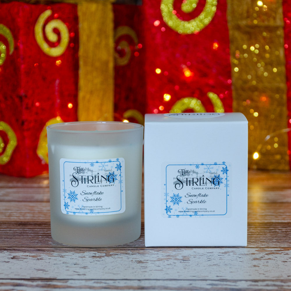Snowflake Sparkle medium frosted glass candle with blue snowflake label and white box