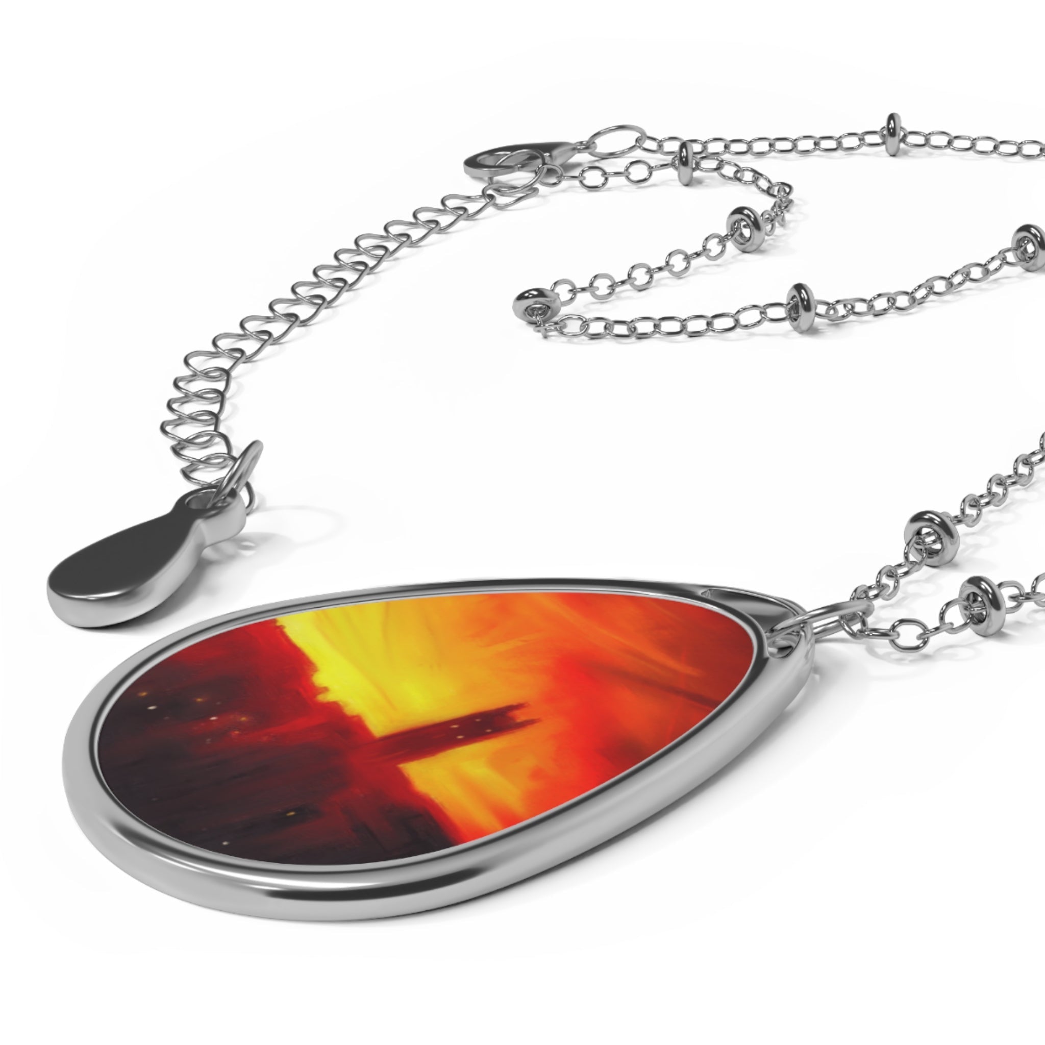 Silver-toned teardrop necklace with abstract red and yellow design inspired by St Stephen’s Church Stockbridge Sunset