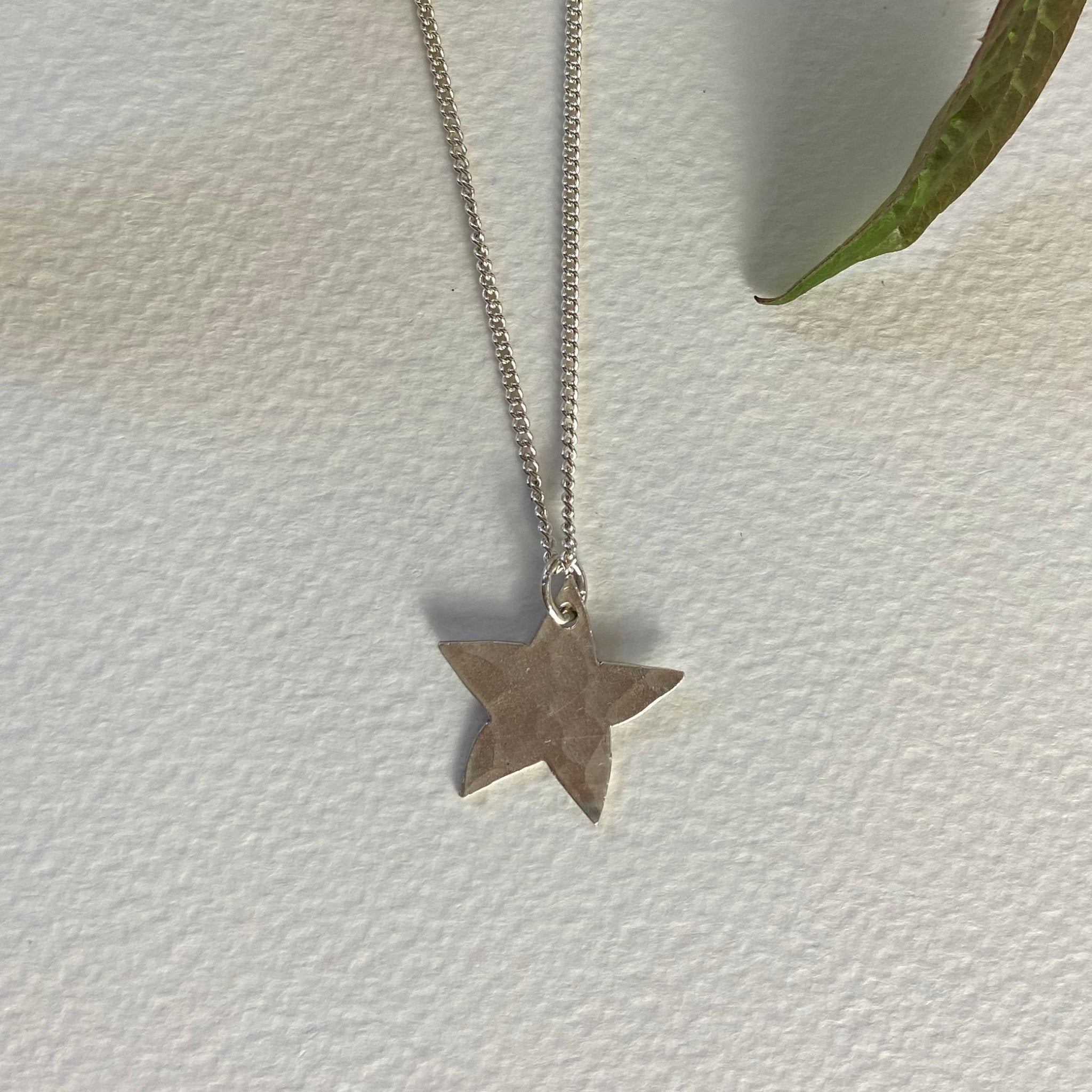 Delicate hammered silver star pendant on fine chain by Genna Miller Jewellery