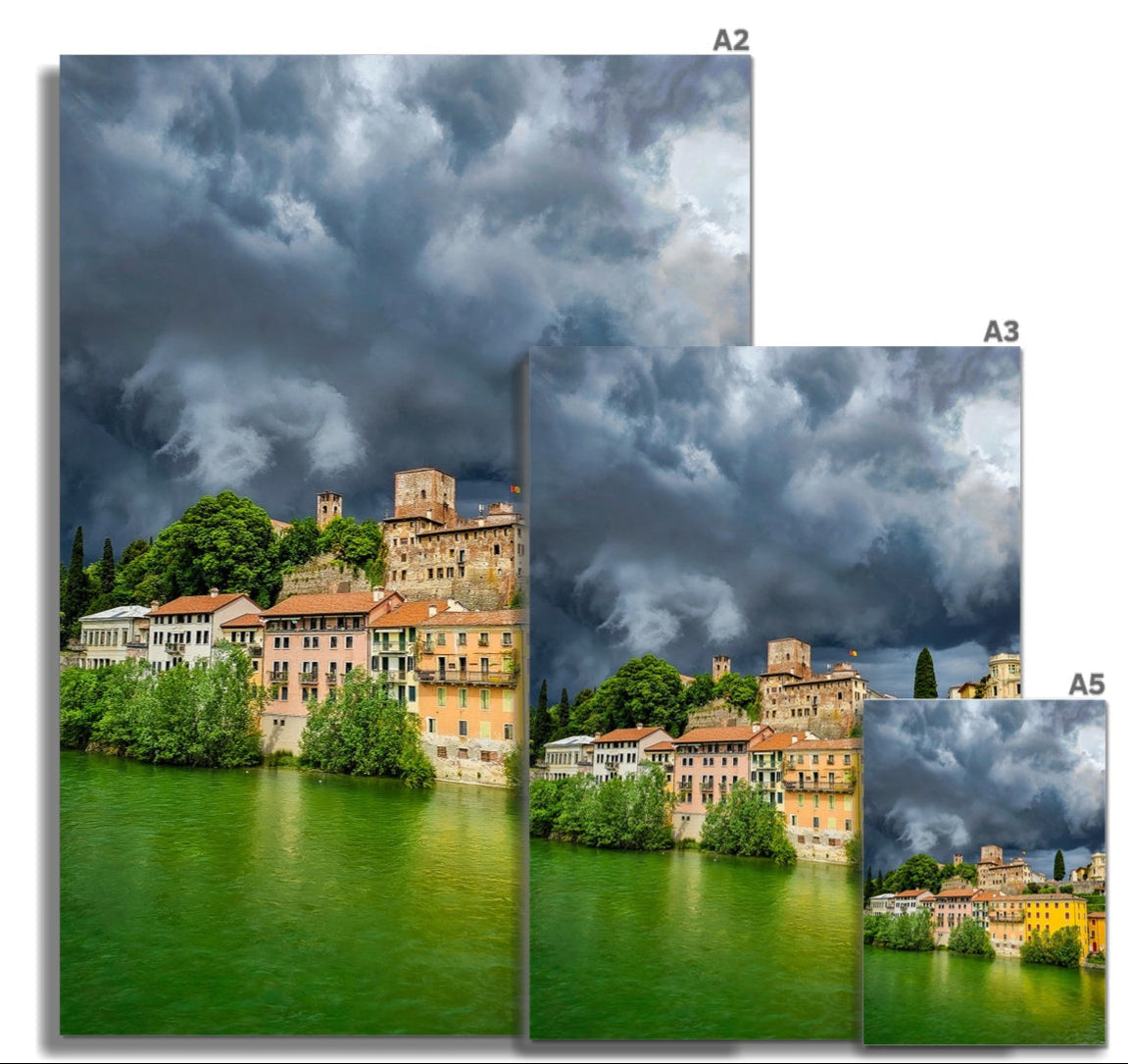 Stormy Bassano del Grappa: terracotta town by green water