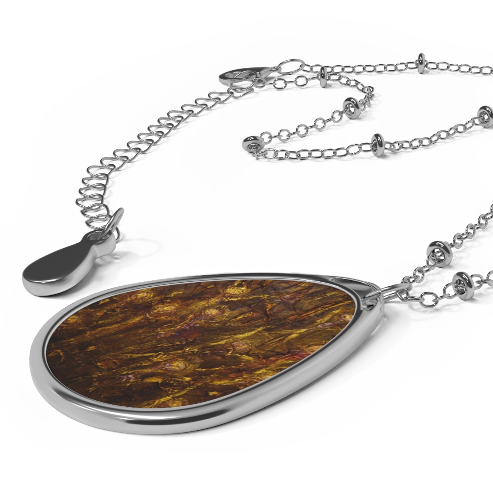 Silver teardrop pendant necklace with textured brown and gold insert from Tam O Shanter Witches collection