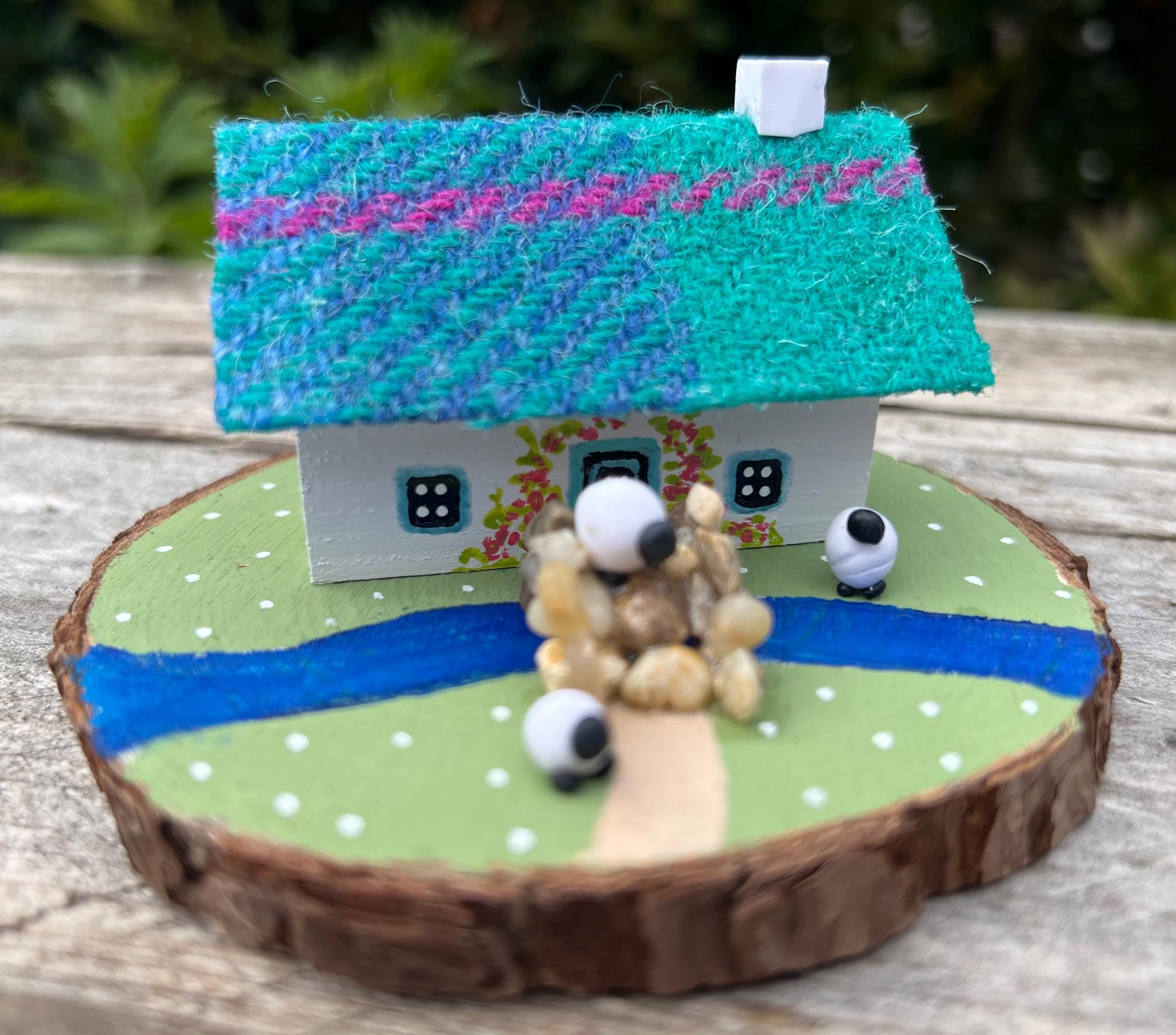 Handcrafted miniature Scottish bothy with teal plaid roof and sheep figurines