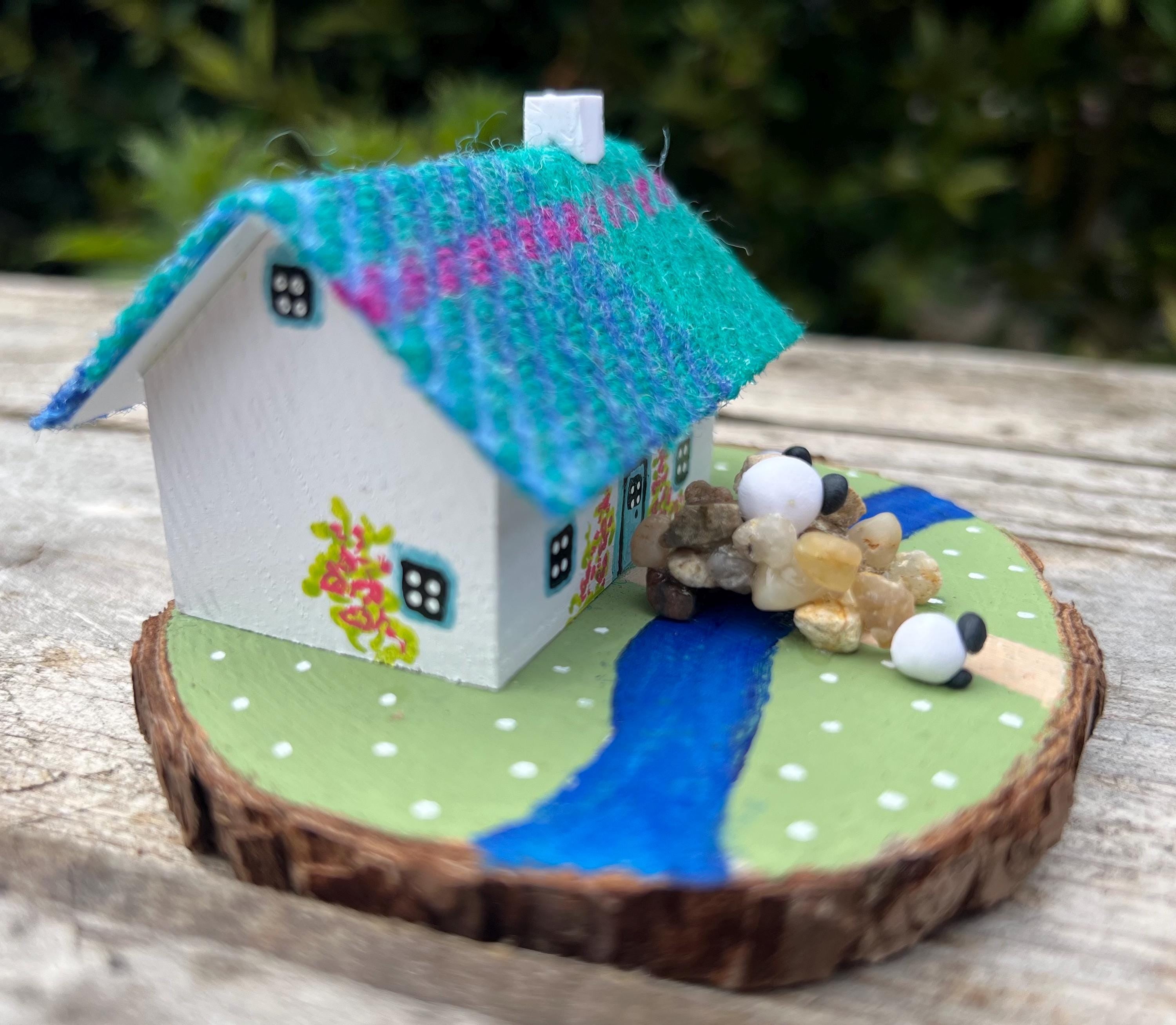 Miniature Scottish Bothy with colorful roof, river, stones, and sheep decor