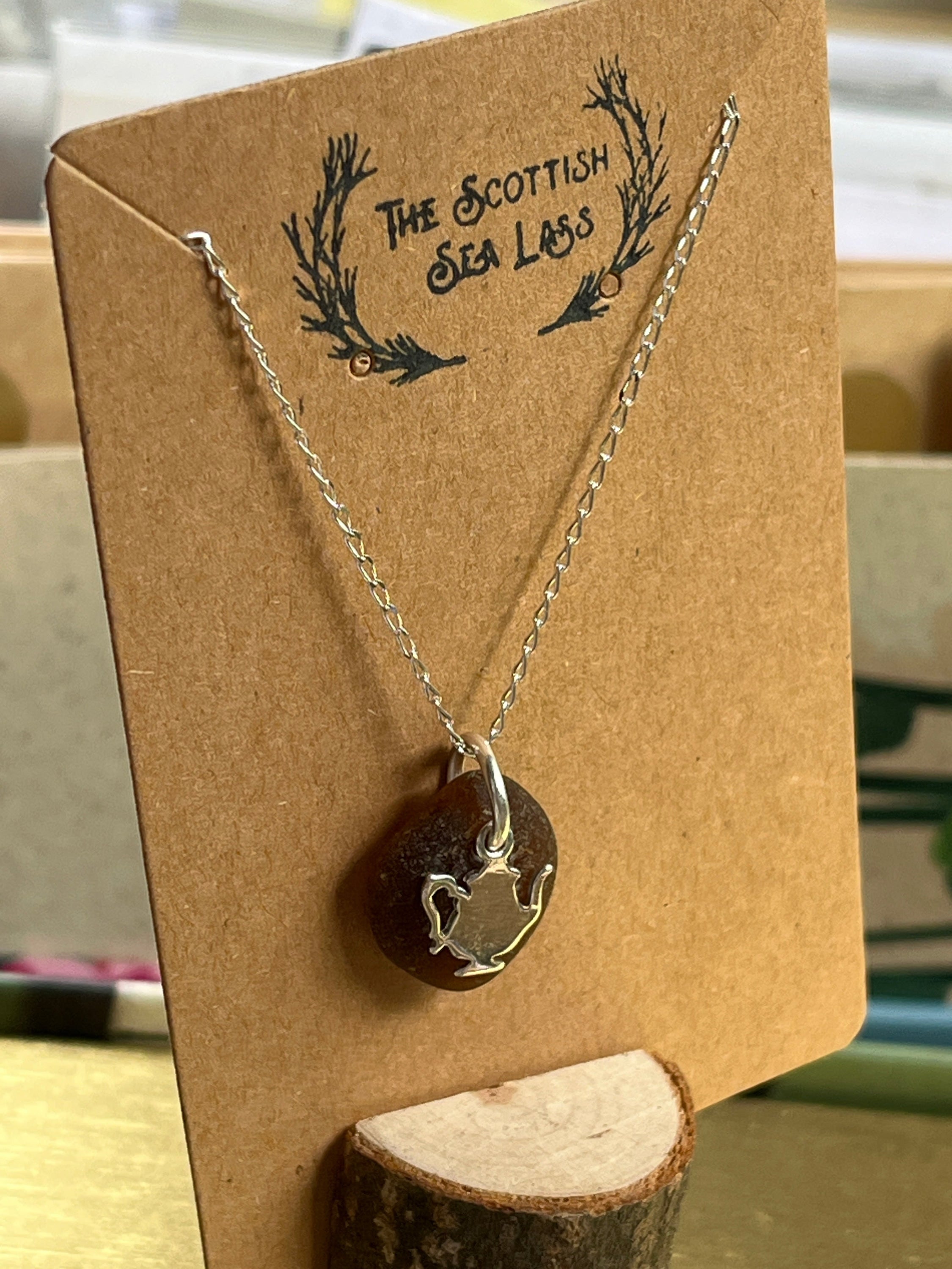 Silver chain necklace with dark circular pendant featuring a silver Teapot Scottish Seaglass 925 design