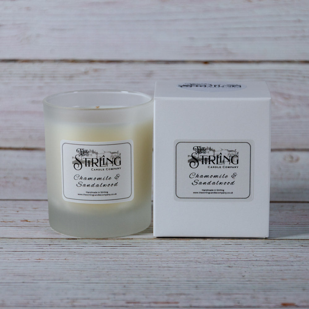 A medium frosted glass candle jar with creamy white chamomile and sandalwood wax from stirling candle company