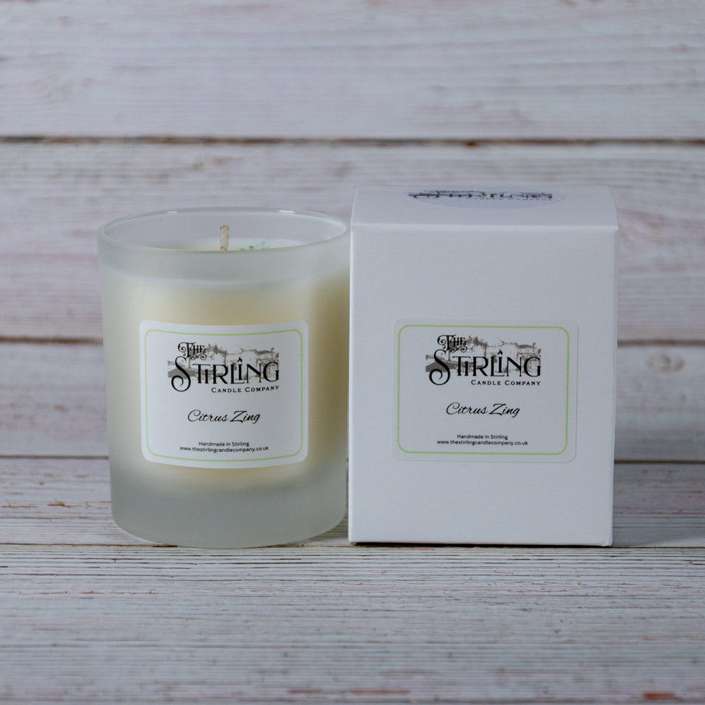 A creamy white citrus zing scented candle in a frosted glass jar from Stirling Candle Company medium size