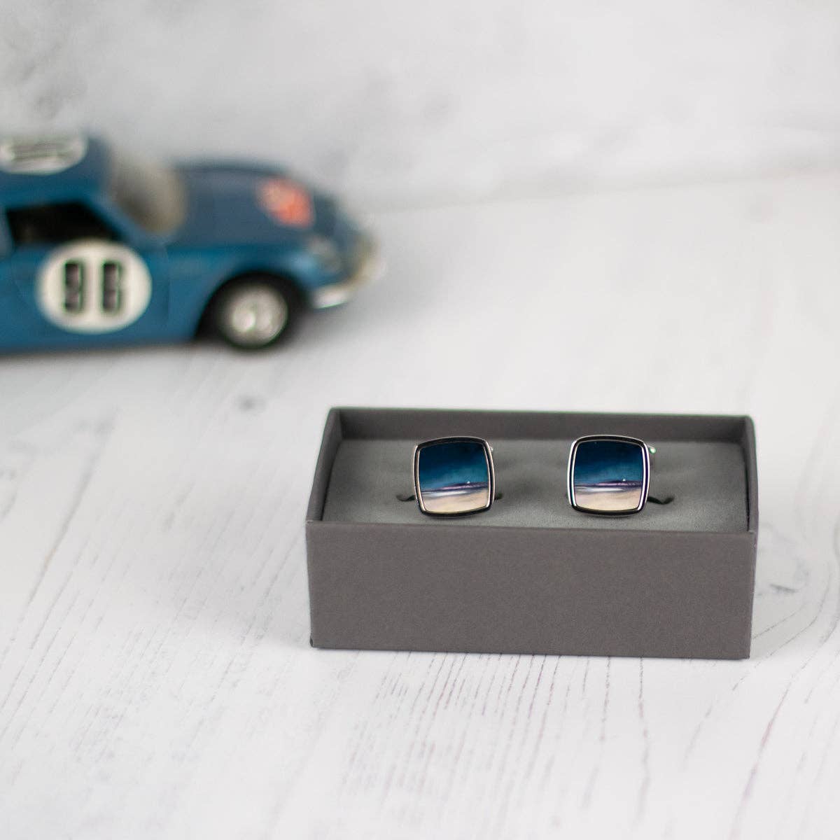 Uist Machair cufflinks in square shape with reflective blue and silver finish in a sleek gray presentation box