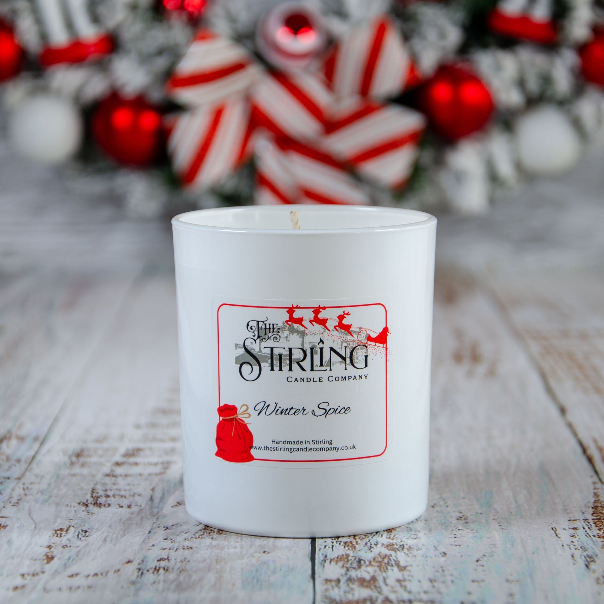 Winter Spice large candle in white ceramic jar with red black label from Stirling Candle Company