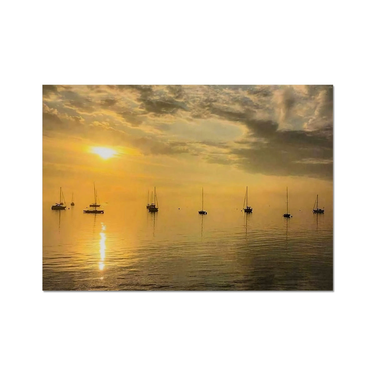 Golden sunset over calm water with silhouetted sailboats in Yachts at Sunset print