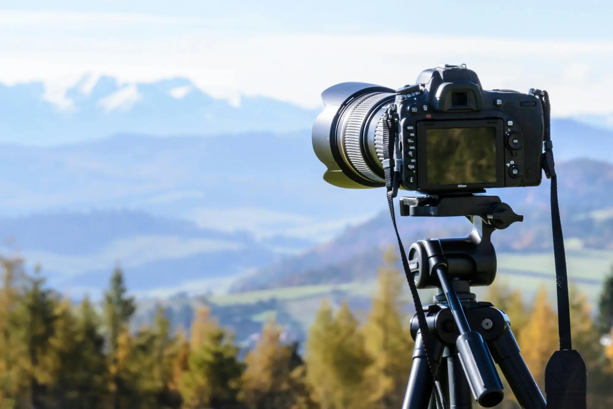 Black DSLR camera with lens on tripod for Scottish landscape photography collection