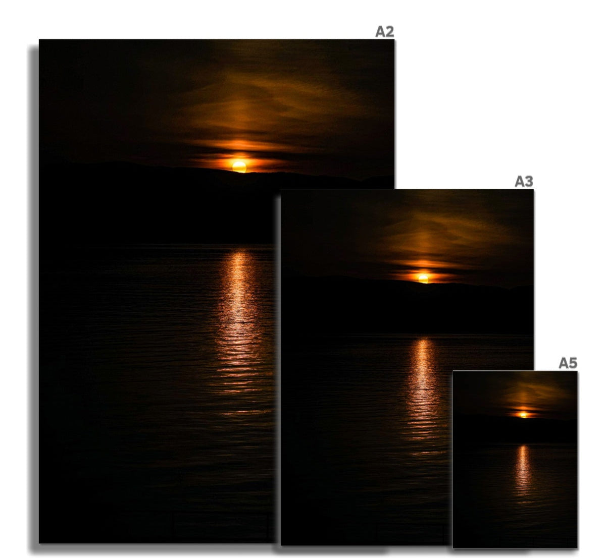 Solstice sunset over the hills of argyll fine art print in a2 a3 and a5 sizes showing an orange sun over dark water reflection