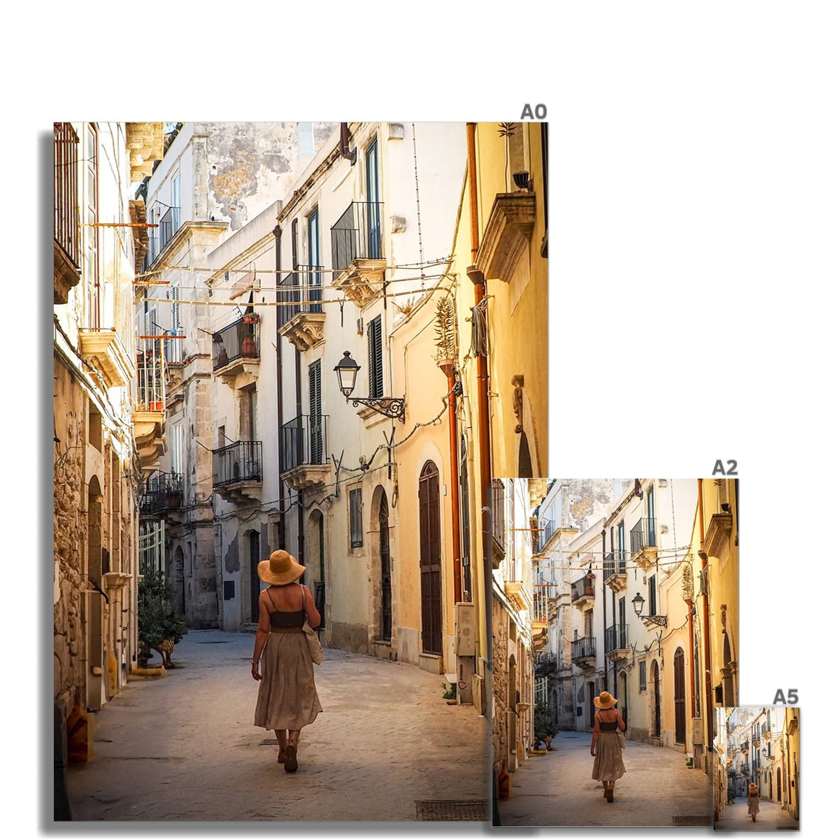 Isla de ortigia fine art print of a woman in a beige dress and straw hat walking a sunlit european alleyway