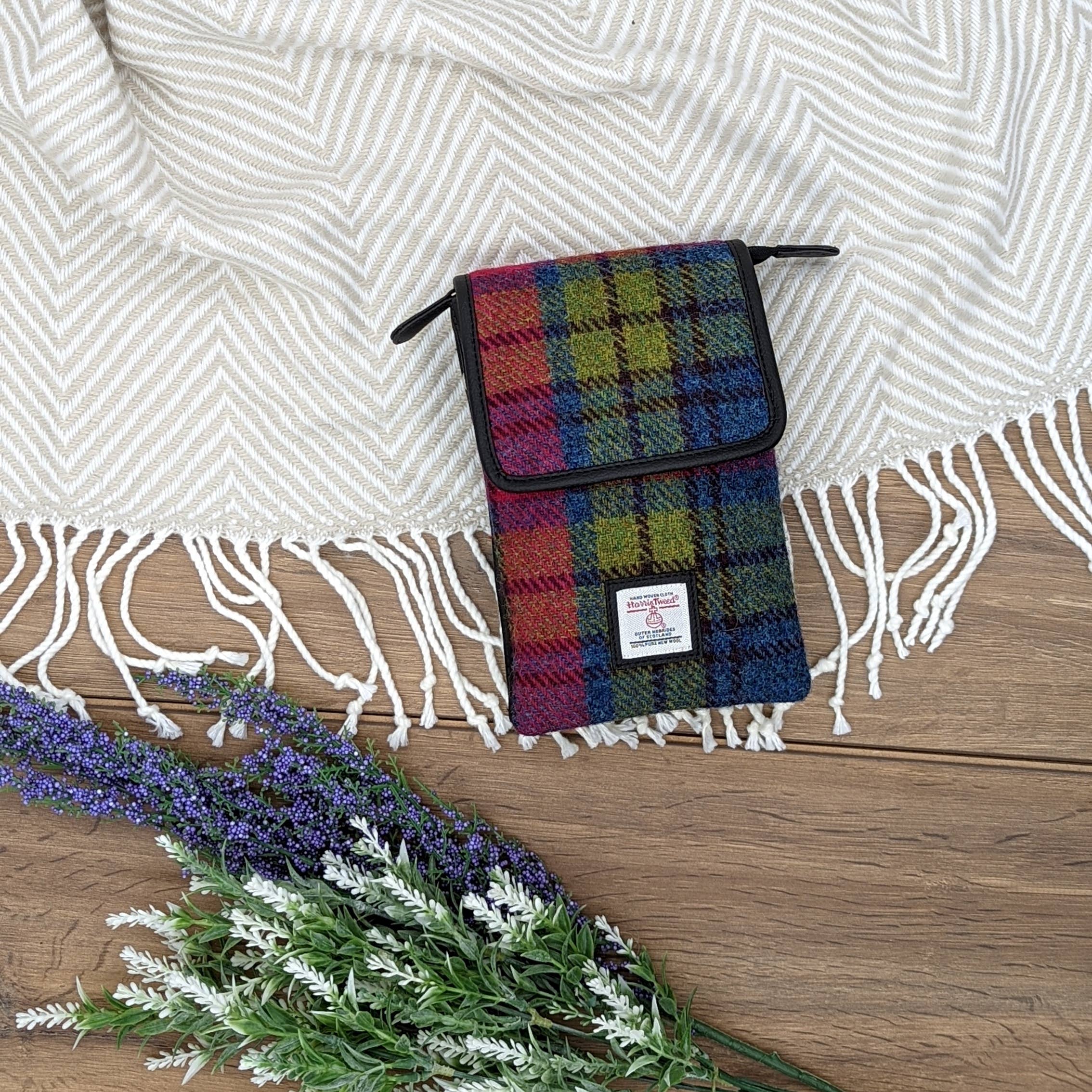 Harris Tweed mini crossbody bag in blue pink check woven harris tweed with black leather trim and brand label