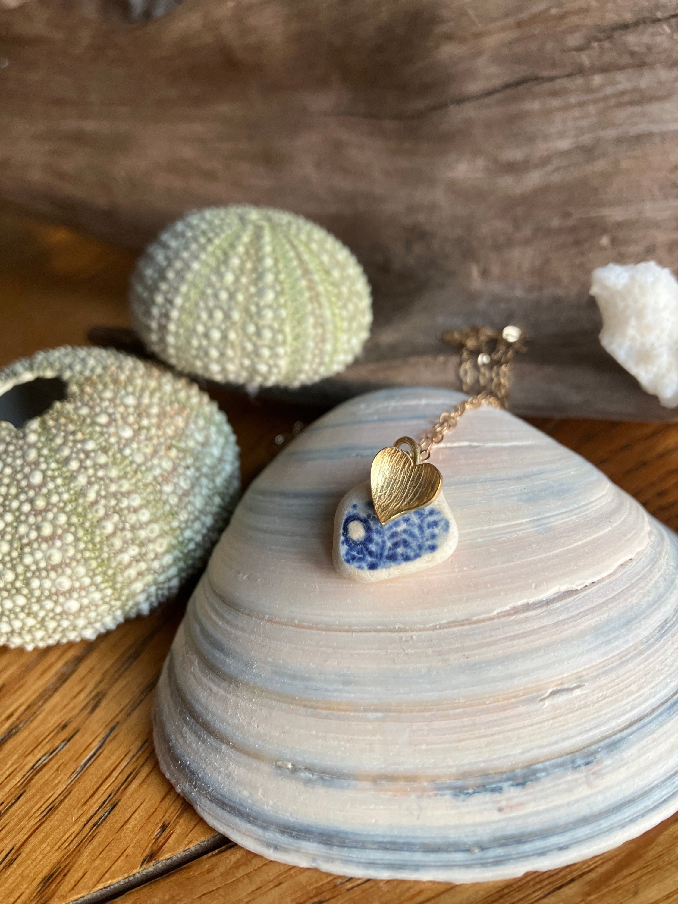 9ct gold heart pendant with blue sea pottery on striped seashell