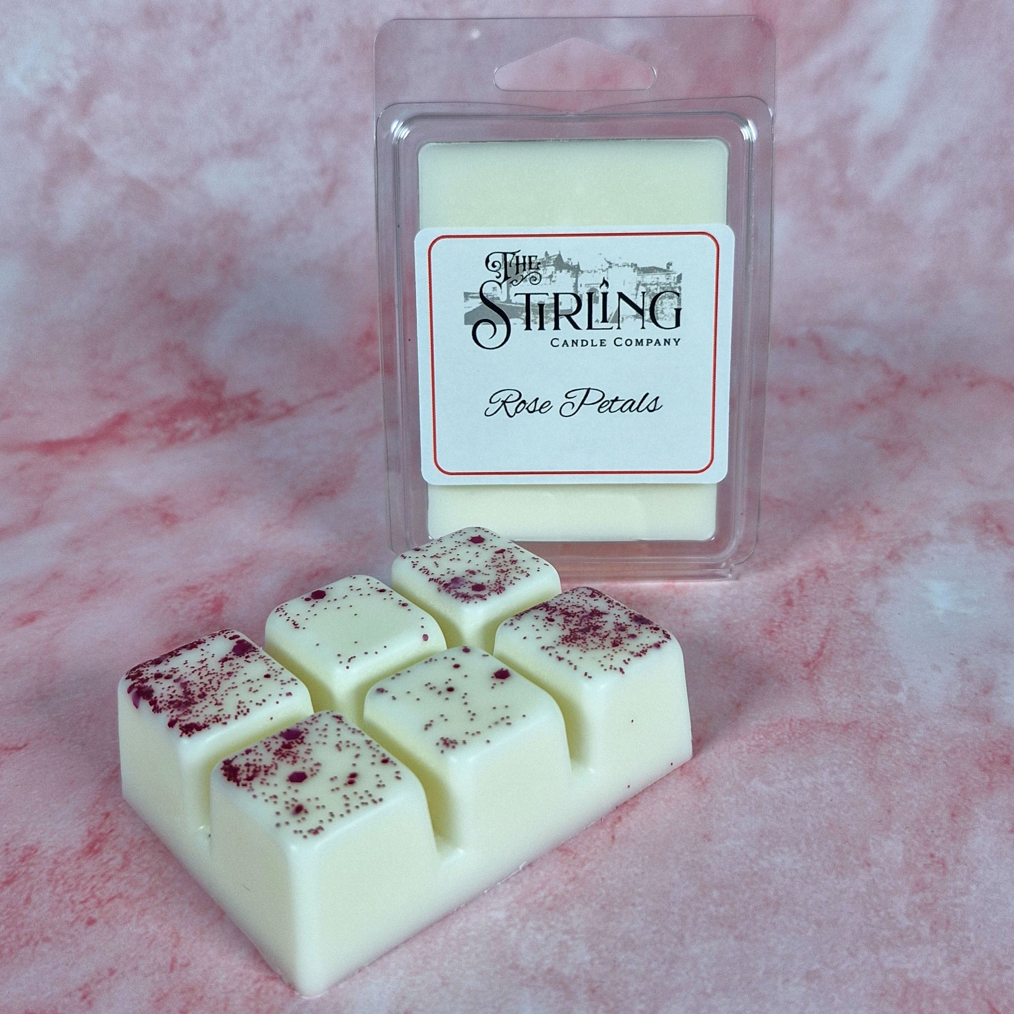 Cream-colored wax melt squares with speckled rose petal finish packaged in clear plastic by Stirling Candle Company