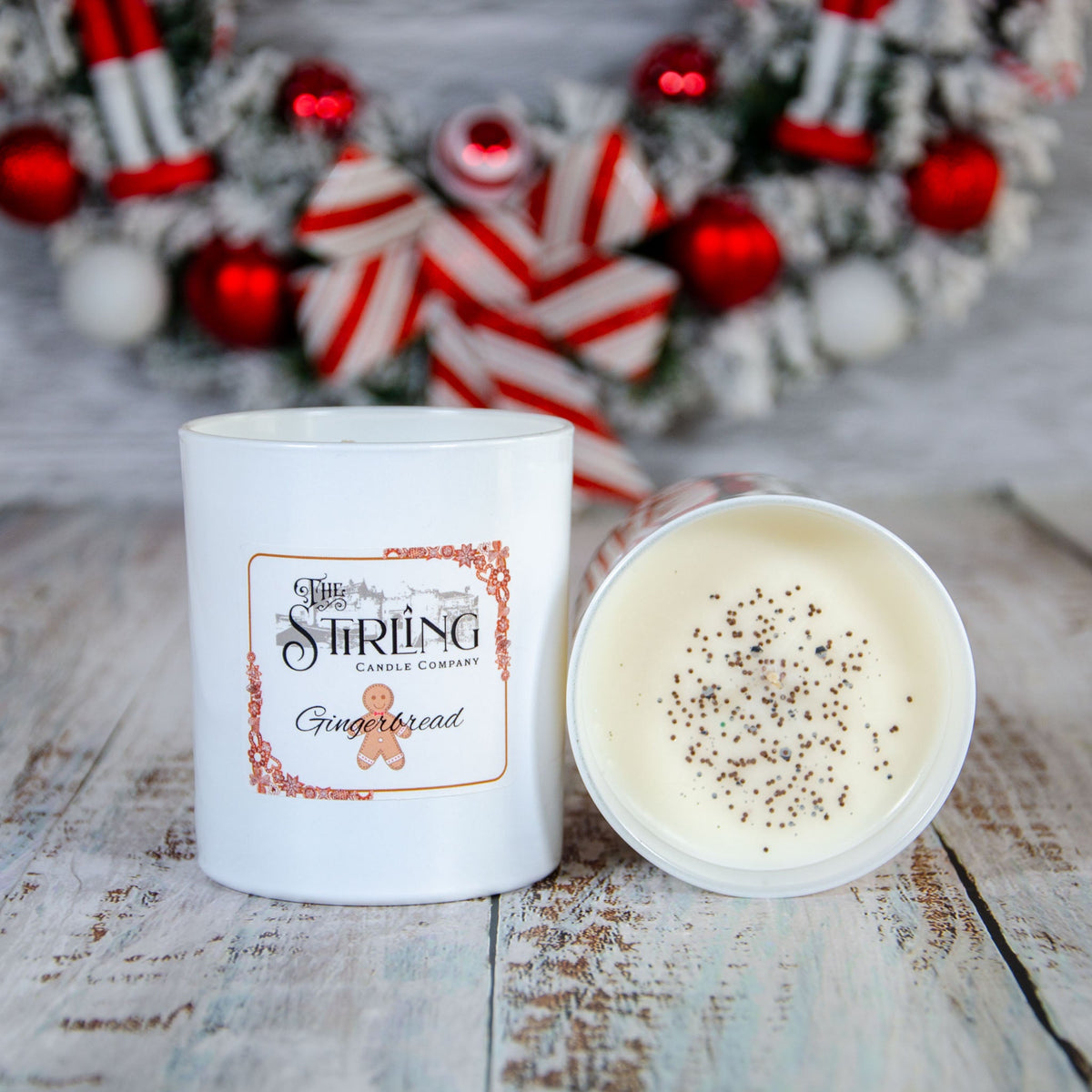 Gingerbread large candle beside its lid, showing dried botanicals on the wax