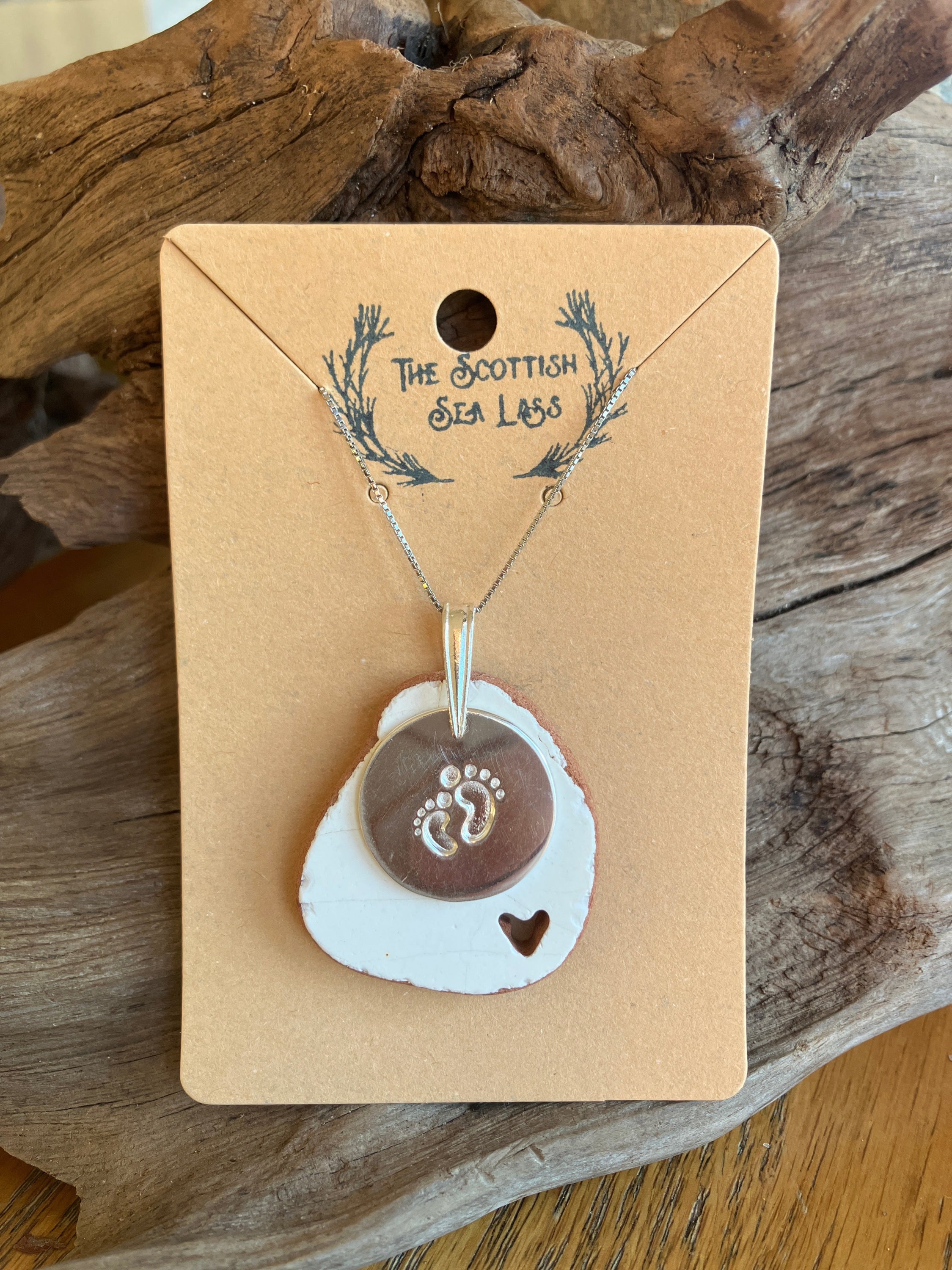 Silver Baby Feet Scottish Sea Pottery 925 Pendant Necklace on brown cardboard backing