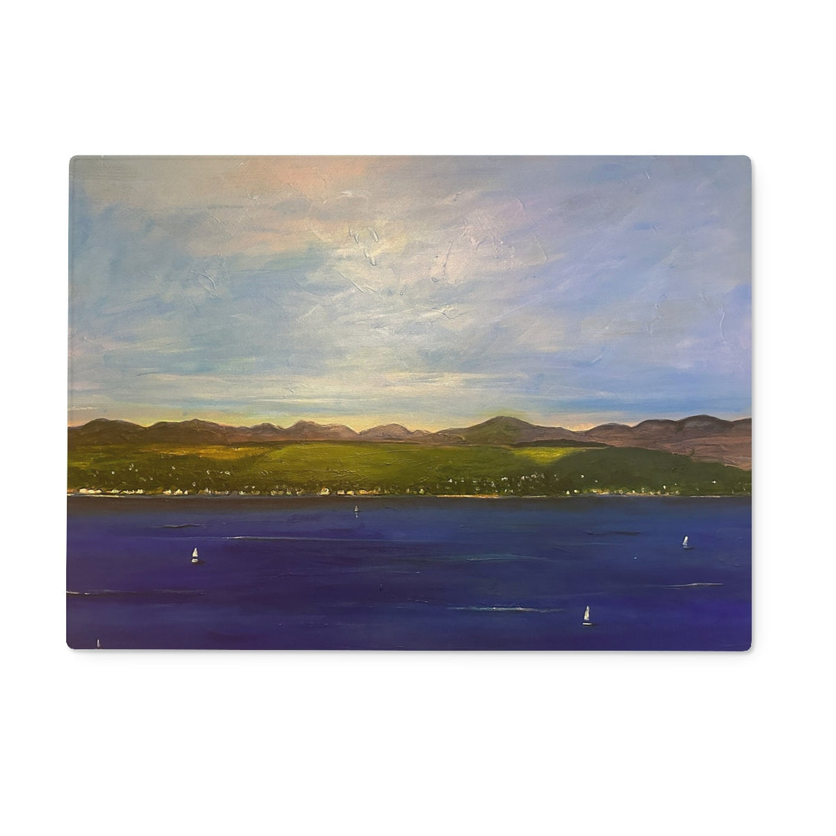 Landscape painting of water with sailboats, green shoreline, hills, and cloudy sky for The Biggie Glass Chopping Board