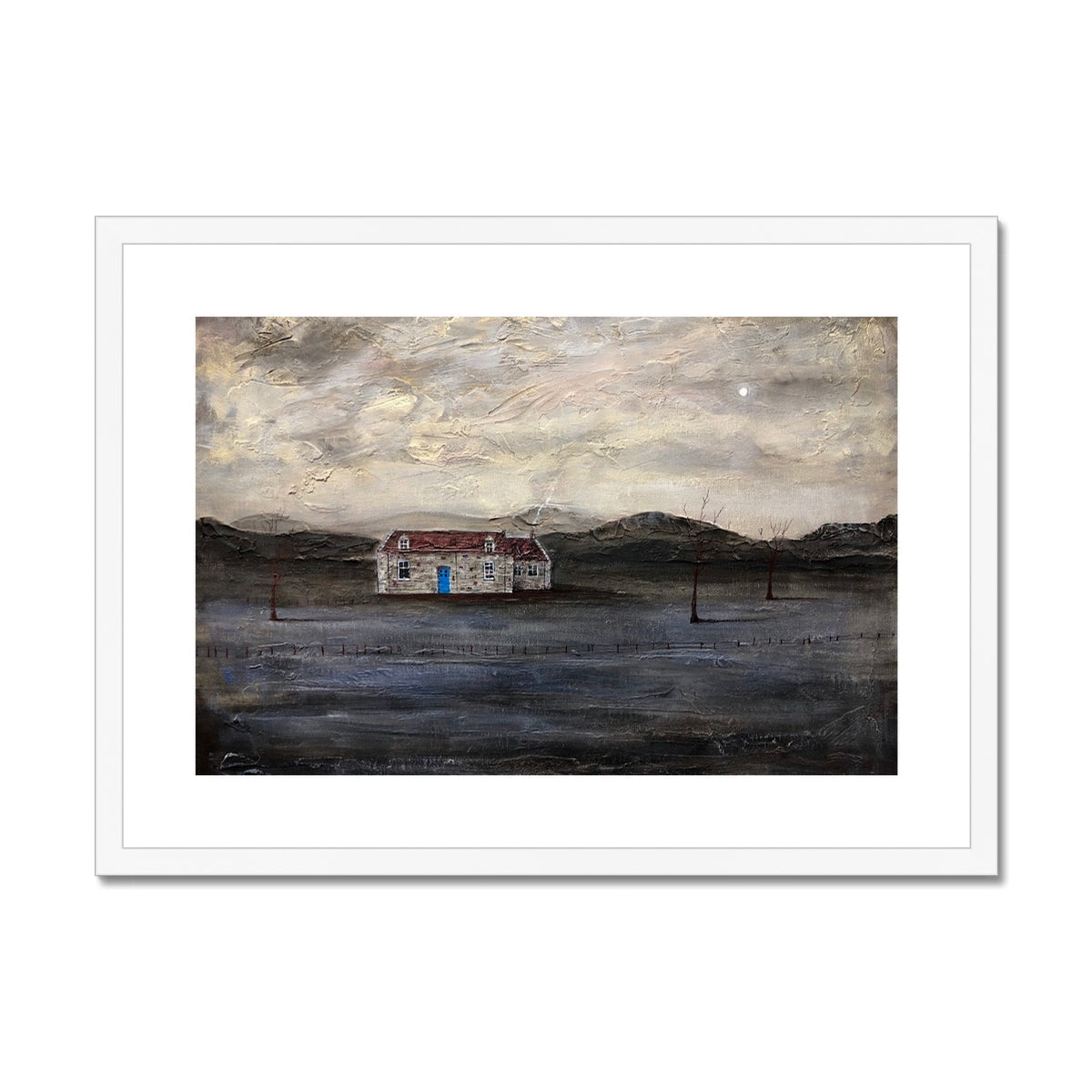 White framed painting of a cottage with a blue door and window against black hills background