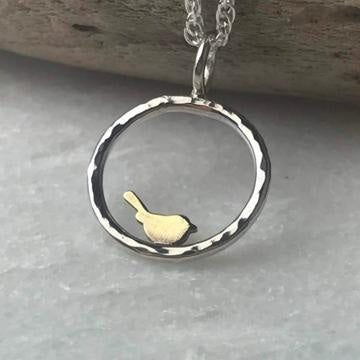 Delicate silver pendant with golden bird in textured frame, Brass Bird Necklace by Lindsay Mcdowall Jewellery