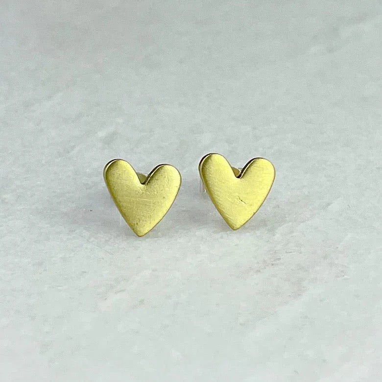 Gold heart-shaped brass stud earrings with smooth textured surface