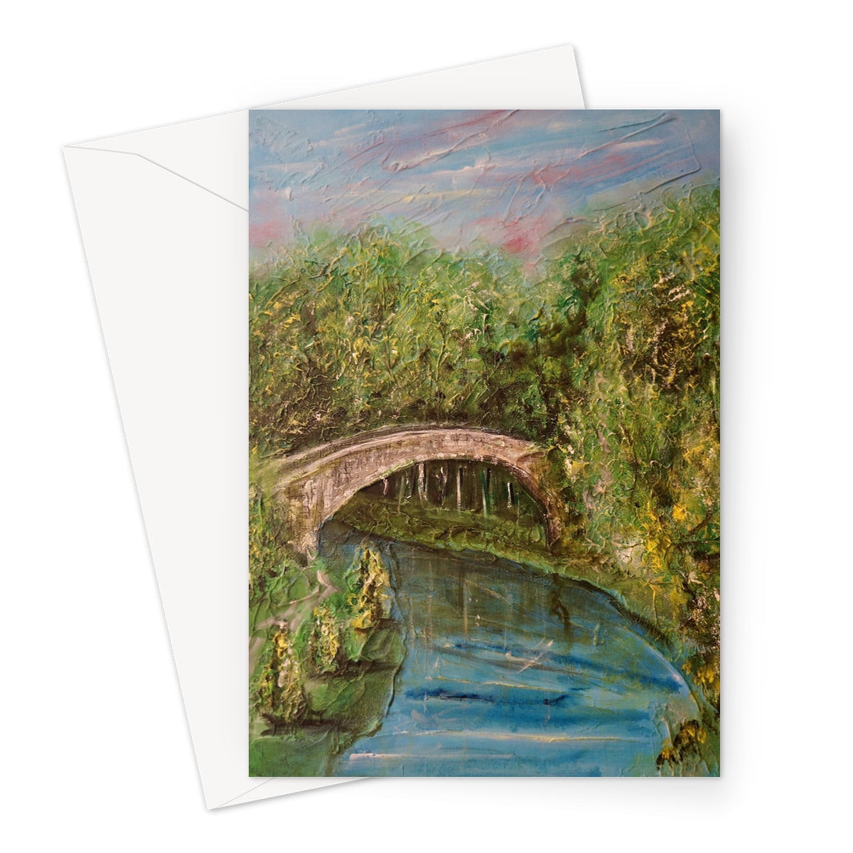 Arched stone Brig O Doon bridge over river with green foliage
