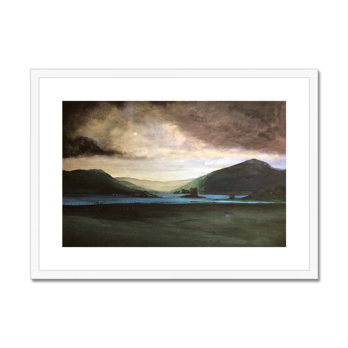 Framed landscape print of a lake, mountains, and a castle under a dramatic sky