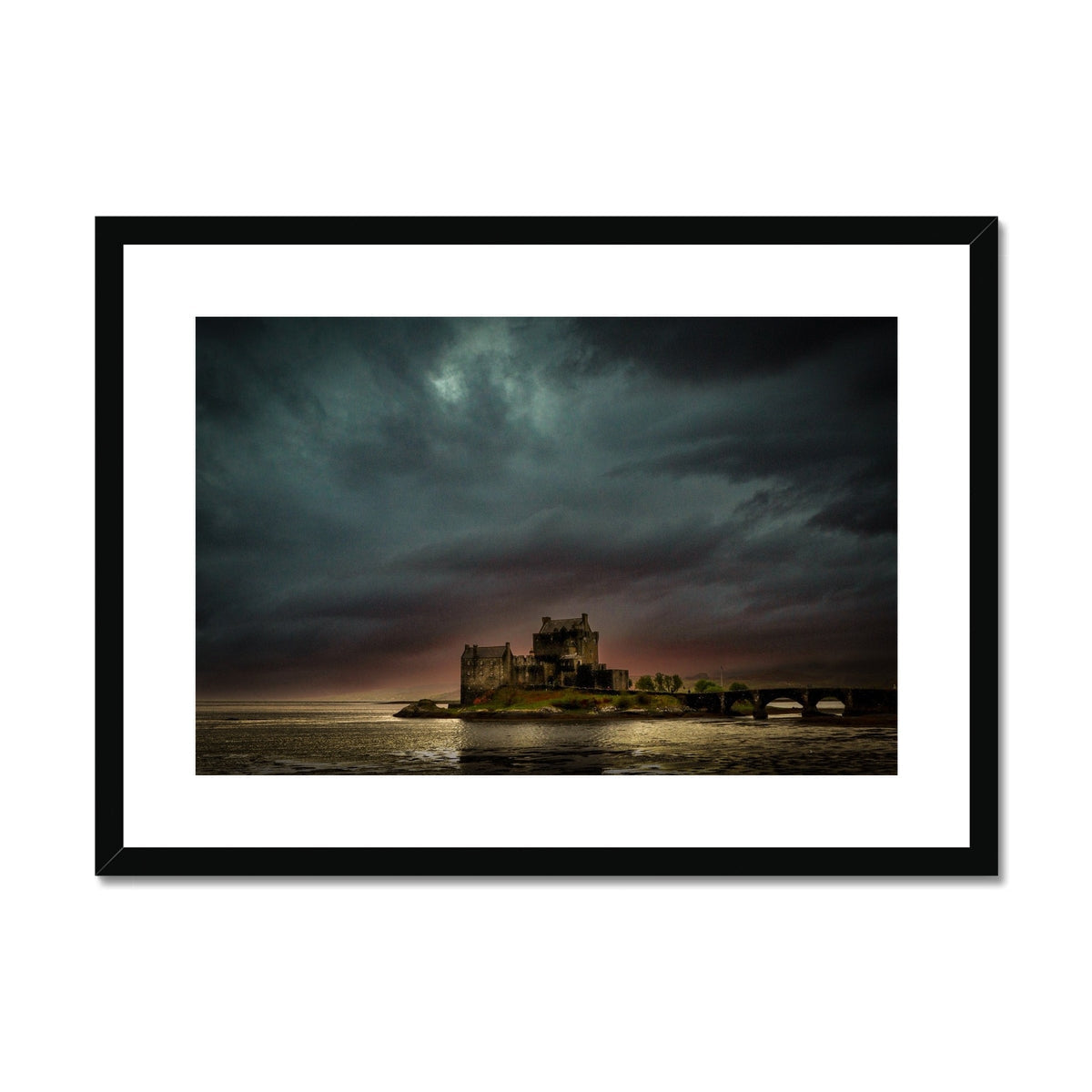 Eilean Donan Castle print with black frame, dramatic sky, water reflection