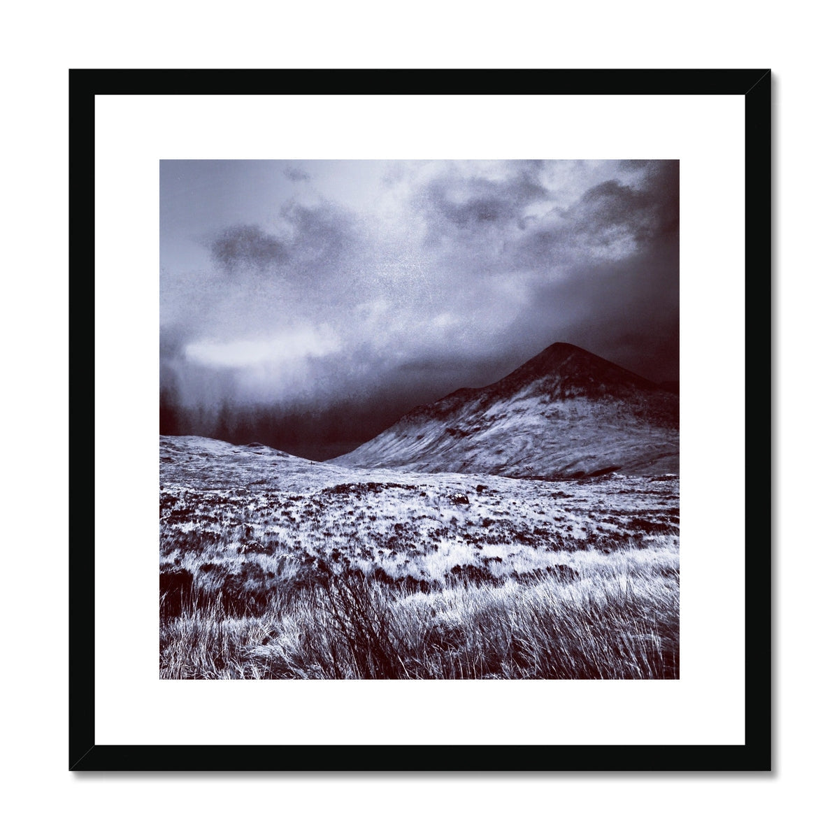 Black framed A Brooding Glen Varagil print of snowy mountains and grassy glen