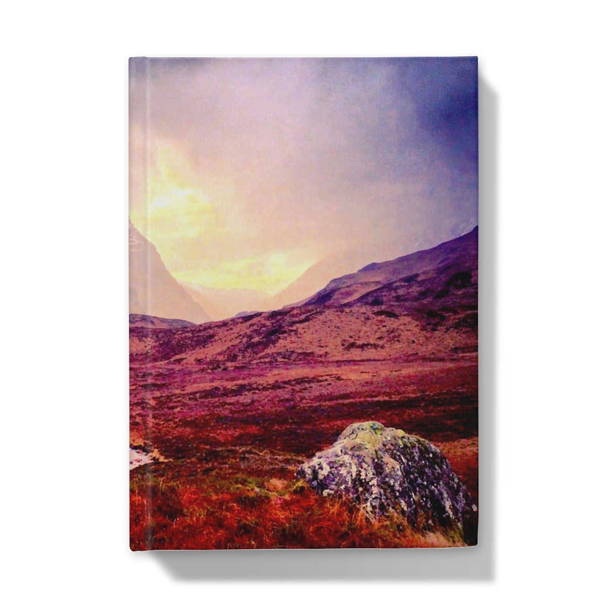 Canvas print of vibrant red purple Glencoe mountain landscape with foreground rock in A Brooding Glencoe Hardback Journal