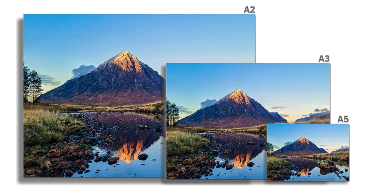 Majestic Buachaille Etive Mòr peak in Glencoe, snow-capped and sunlit, reflected in stream