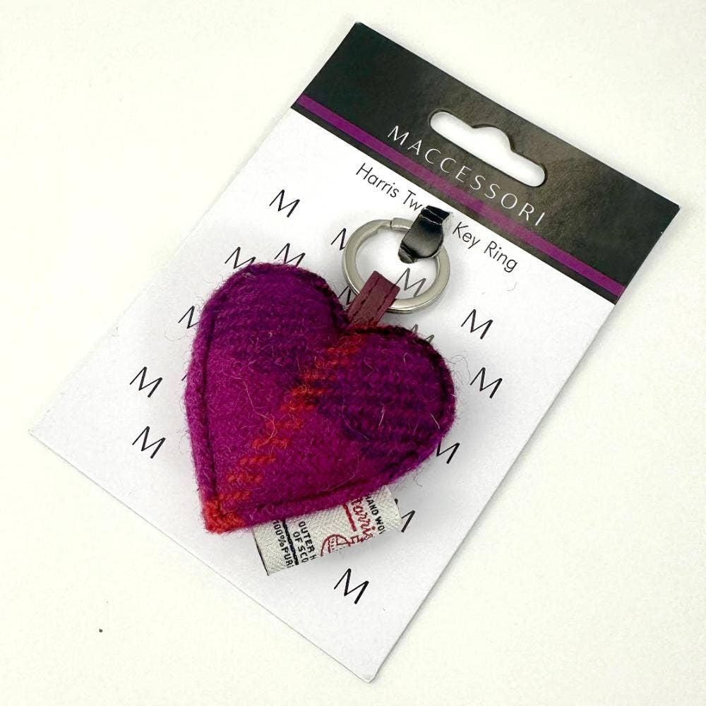 A vibrant purple heart-shaped keyring made from Harris Tweed fabric with a silver metal ring and leather tab