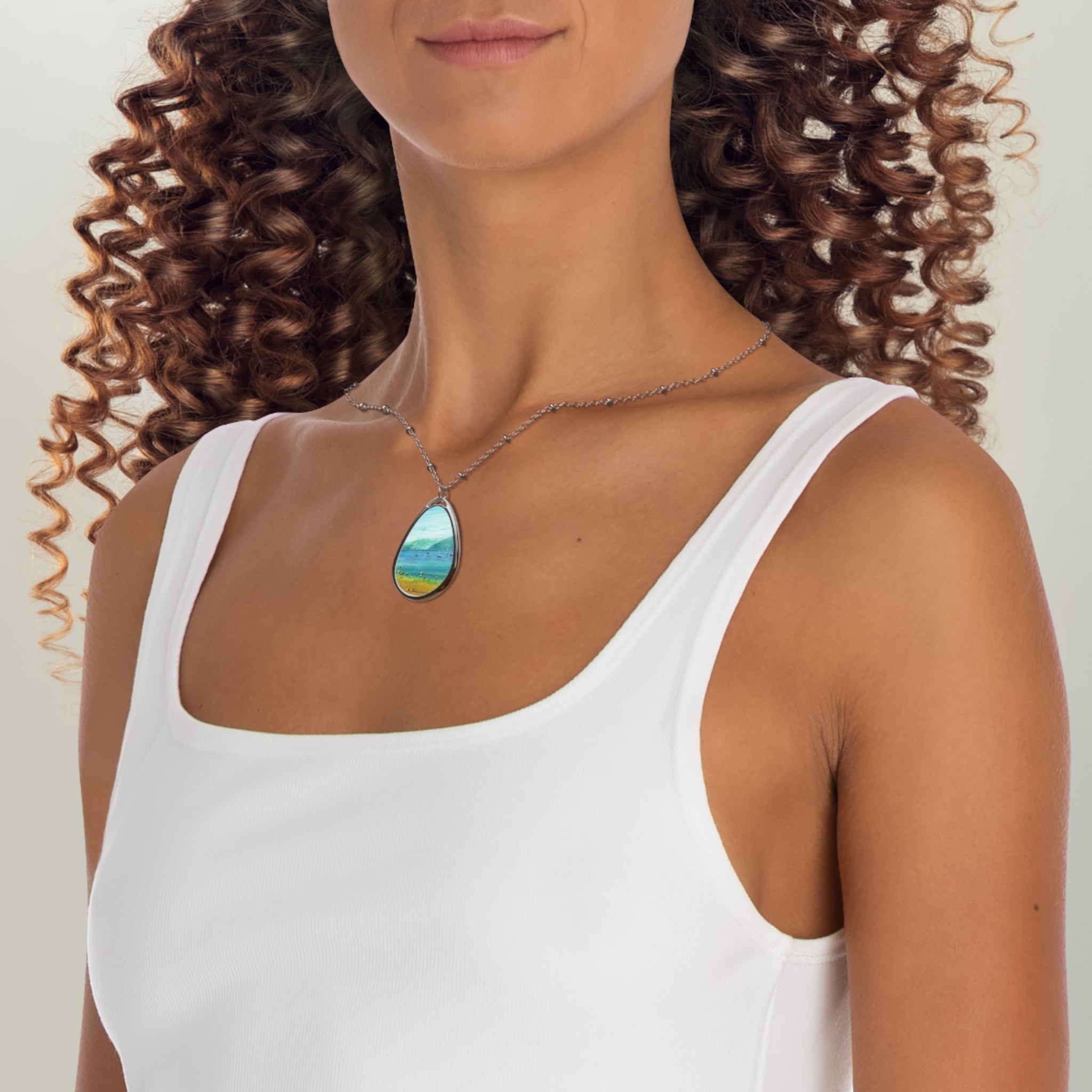 Woman in white tank top wearing Clyde Summers Day Scottish Art Jewellery necklace with colorful landscape pendant