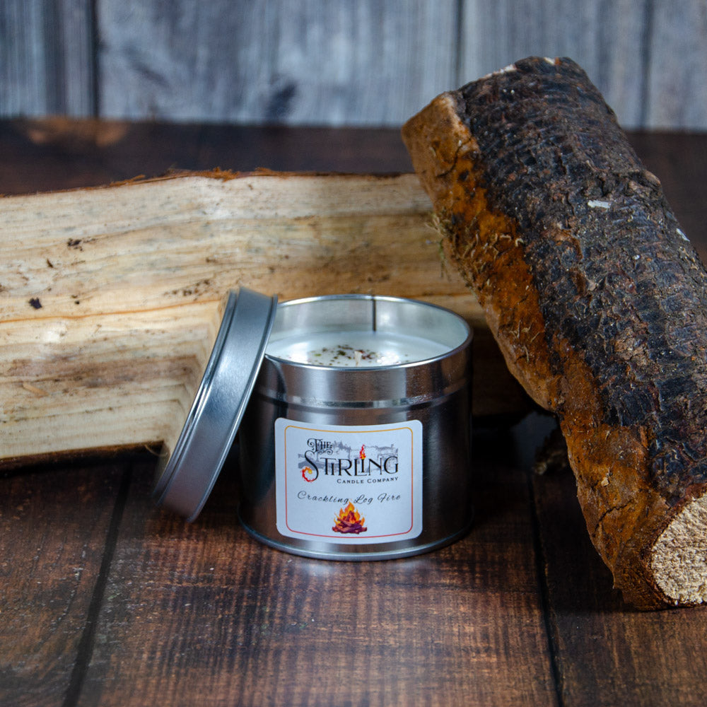 Crackling log fire travel tin candle by Stirling Candle Company with white wax and rustic logs