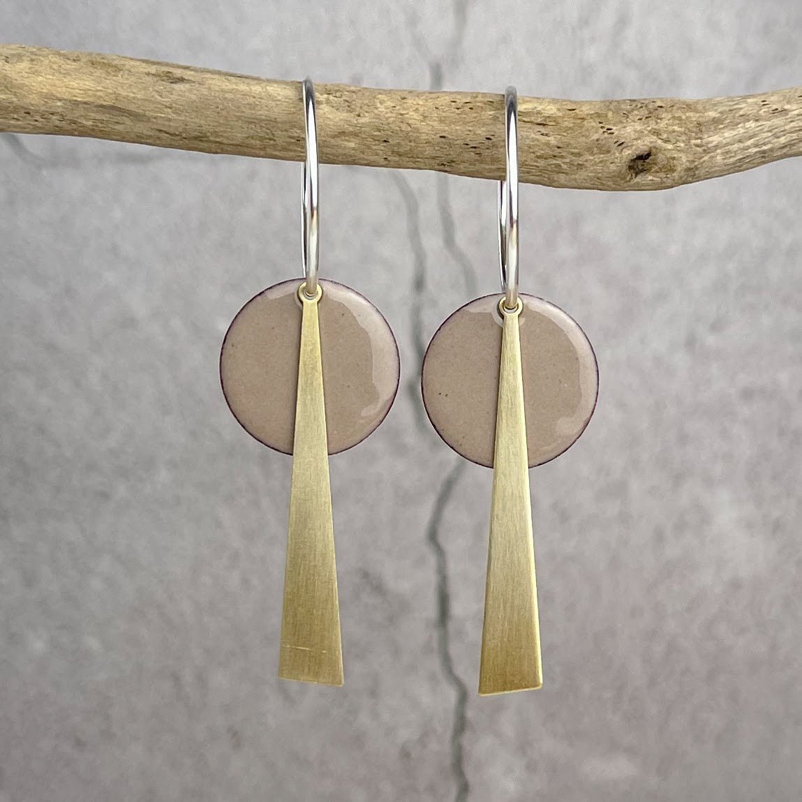 Dove Grey geometric earrings featuring silver and brass drop design with circular beige disc above a vertical bar