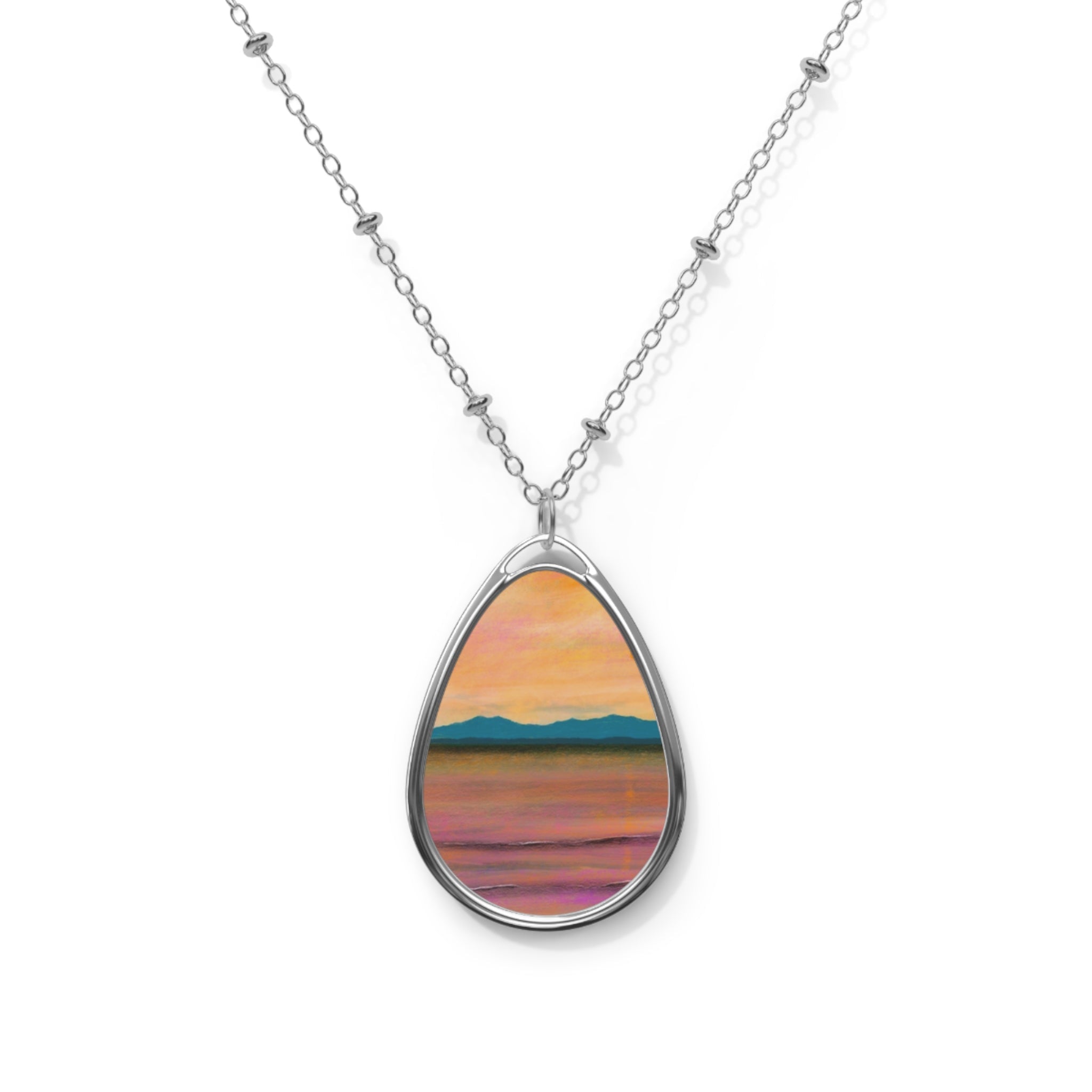 Silver chain necklace with oval pendant showcasing colorful abstract landscape design
