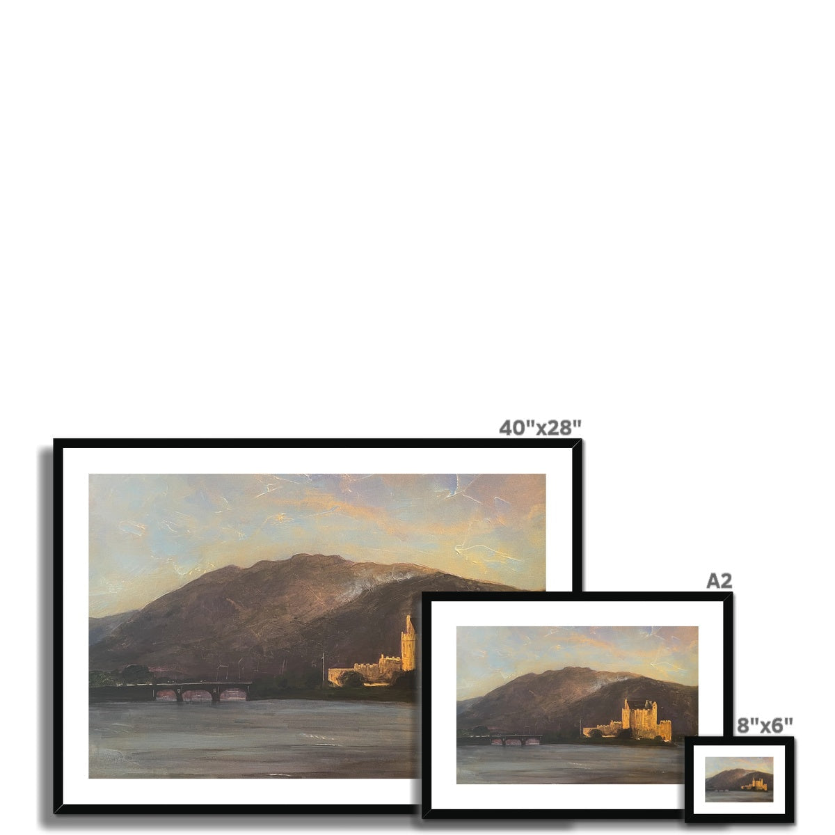 Set of three framed landscape prints of Eilean Donan Castle by a lake at sunset