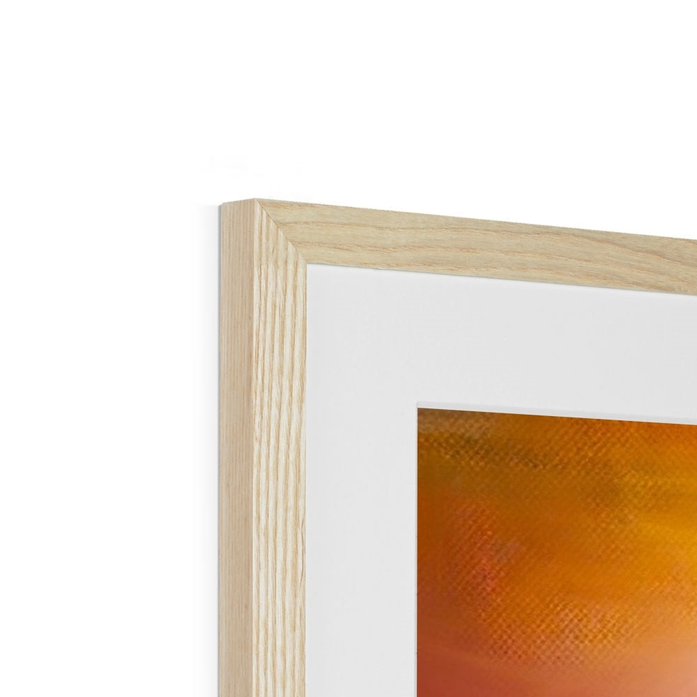 Light wood-framed art with white mat featuring an orange-toned sunset painting of Eilean Donan Castle