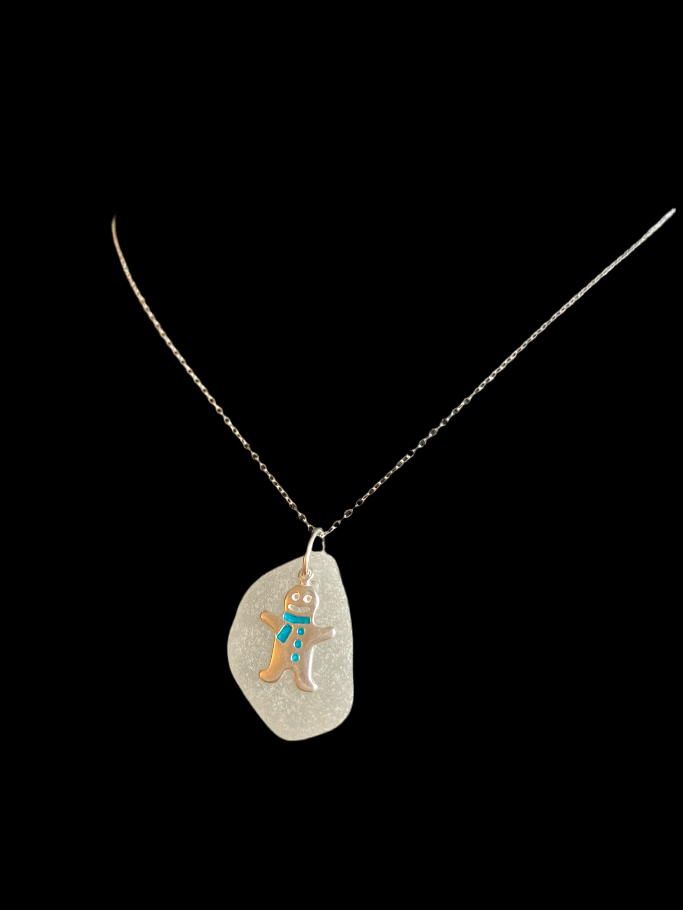 Silver chain necklace with translucent white sea glass pendant and gingerbread man charm