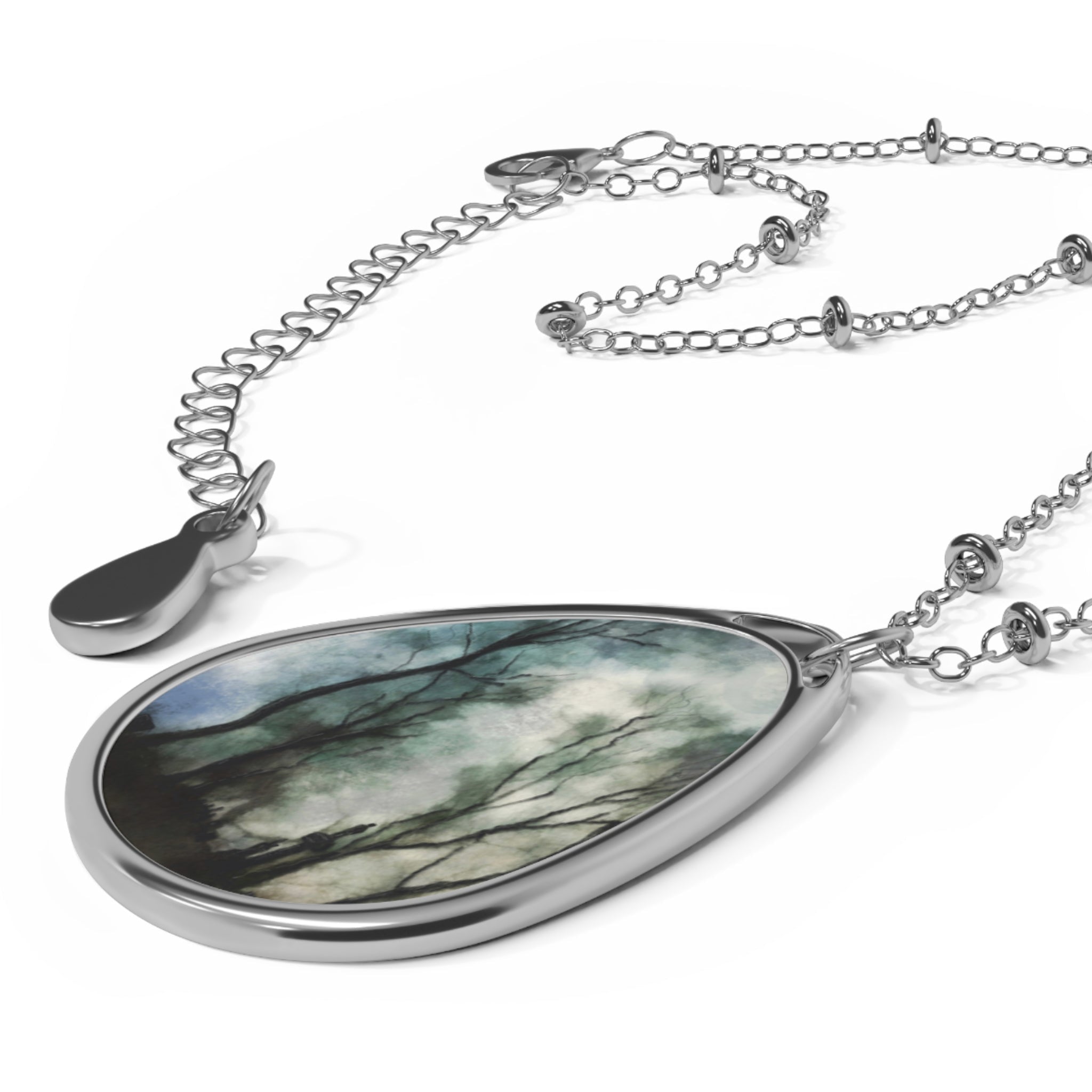 Silver necklace with teardrop pendant featuring misty tree-branch design from Glasgow Necropolis Moonlight collection