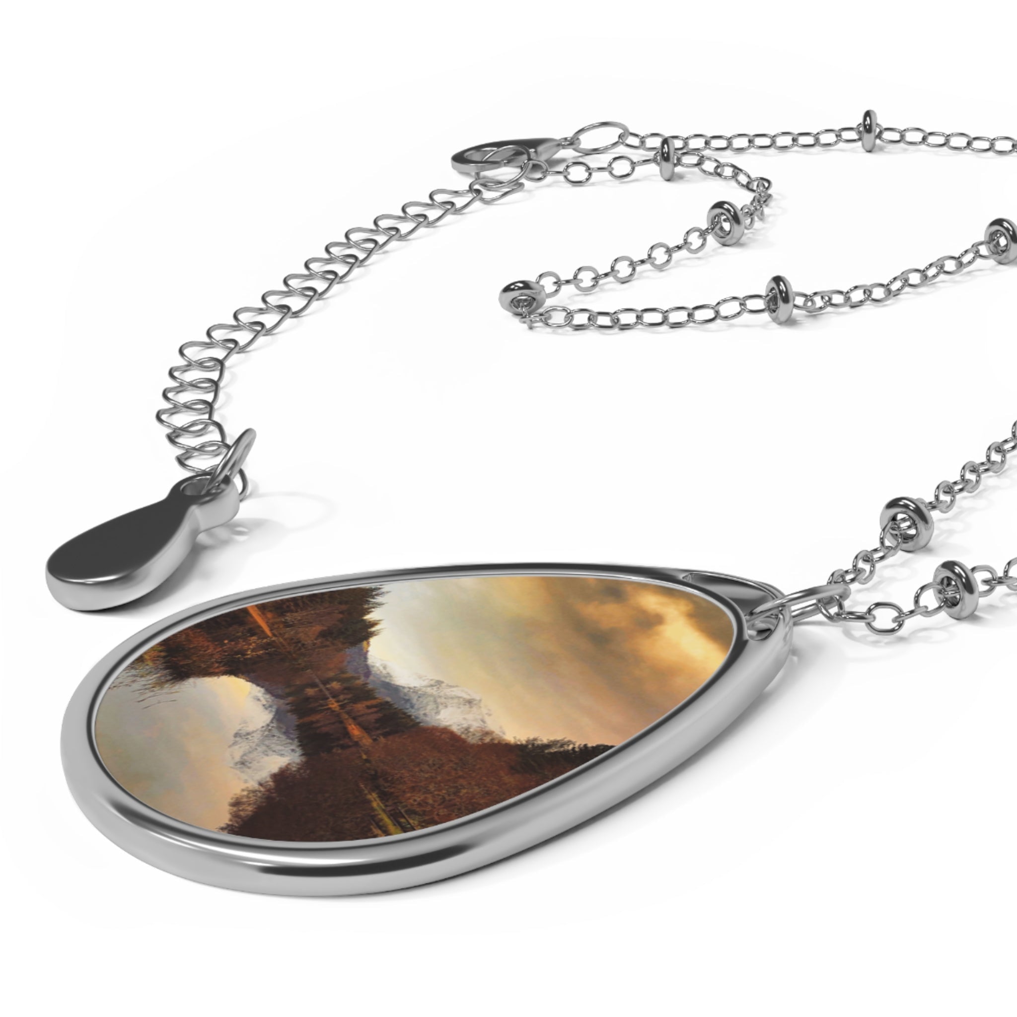 Glencoe Lochan Dusk silver teardrop pendant necklace with amber trees and sky